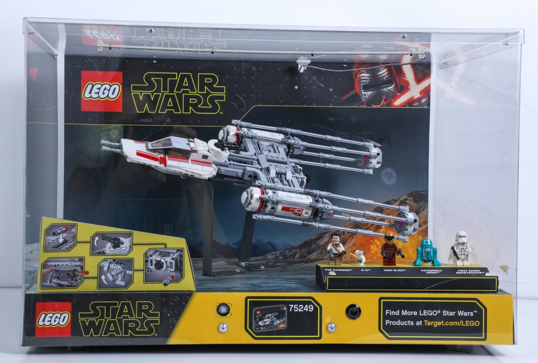 Disney Star Wars Lego Store Display: (Disney, c. 2019). A store used display for a LEGO Star Wars: The Rise of Skywalker Resistance Y-Wing Starfighter. The display includes an assembled starship in a display case with custom background,