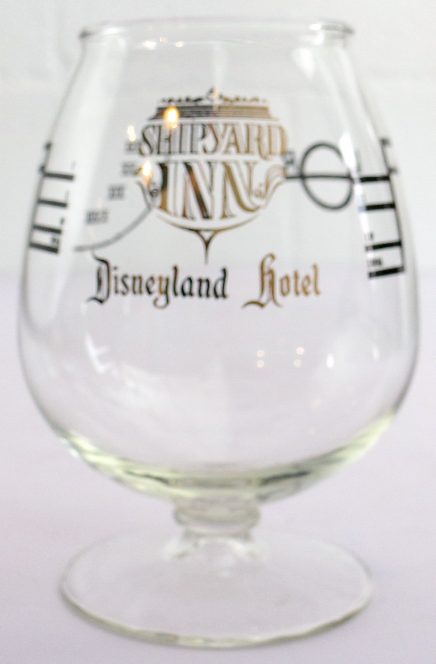 Disneyland Hotel Shipyard Inn Souvenir Bundle: (Disneyland Hotel, 1990s) A Disneyland Hotel Shipyard Inn Brandy Snifter. This souvenir brandy snifter features the logo of the restaurant in gold font with imagery related to the aged spirits once of