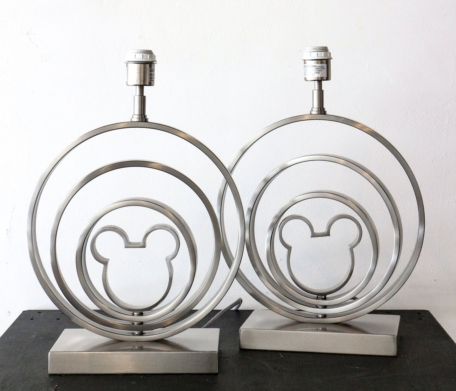 Pair of Metal Mickey Logo Lamps.: (Disney, 2017) This is a very rare pair of Mickey logo metal desk lamps. The center two rings and Mickey logo center can rotate for a variety of designs that best compliment your home. The sleek metal