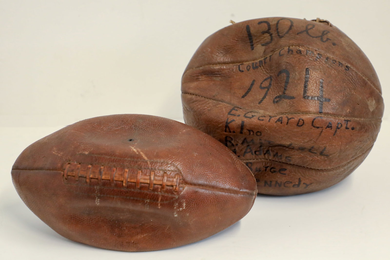 Pair of Buena Vista Street Vintage Leather Display Football and Basketball Props.: (California Adventure, c. 2010s) This is a vintage leather football and basketball that were used as display props within California Adventure. The period shops of Buena Vista Street often carry vinta