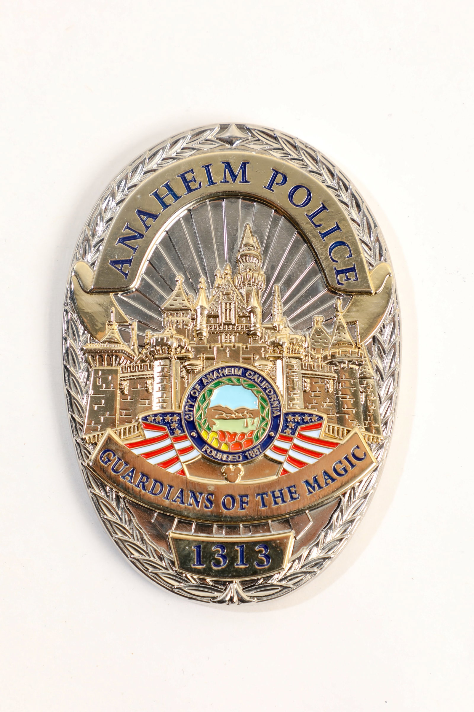 Anaheim Police Department Badge Disneyland Challenge Coin.: (Disneyland, c. 2010s) This is a gorgeous metal "challenge coin" designed to resemble a badge for the Anaheim Police. The front reads "Guardians of the Magic" below a dimensional image of Sleeping Bea