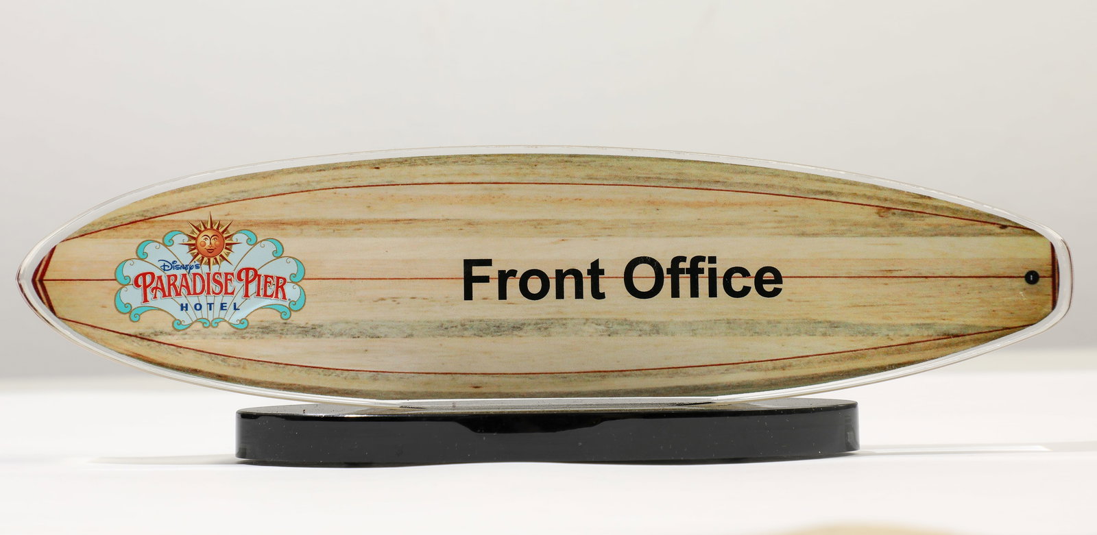 Paradise Pier Hotel Front Office Surfboard Display.: (California Adventure, c. 2010s) This is a charming surfboard-style desk accessory from the Paradise Pier Hotel at the Disneyland Resort. Featuring the logo for the hotel at the left and the text "Fro