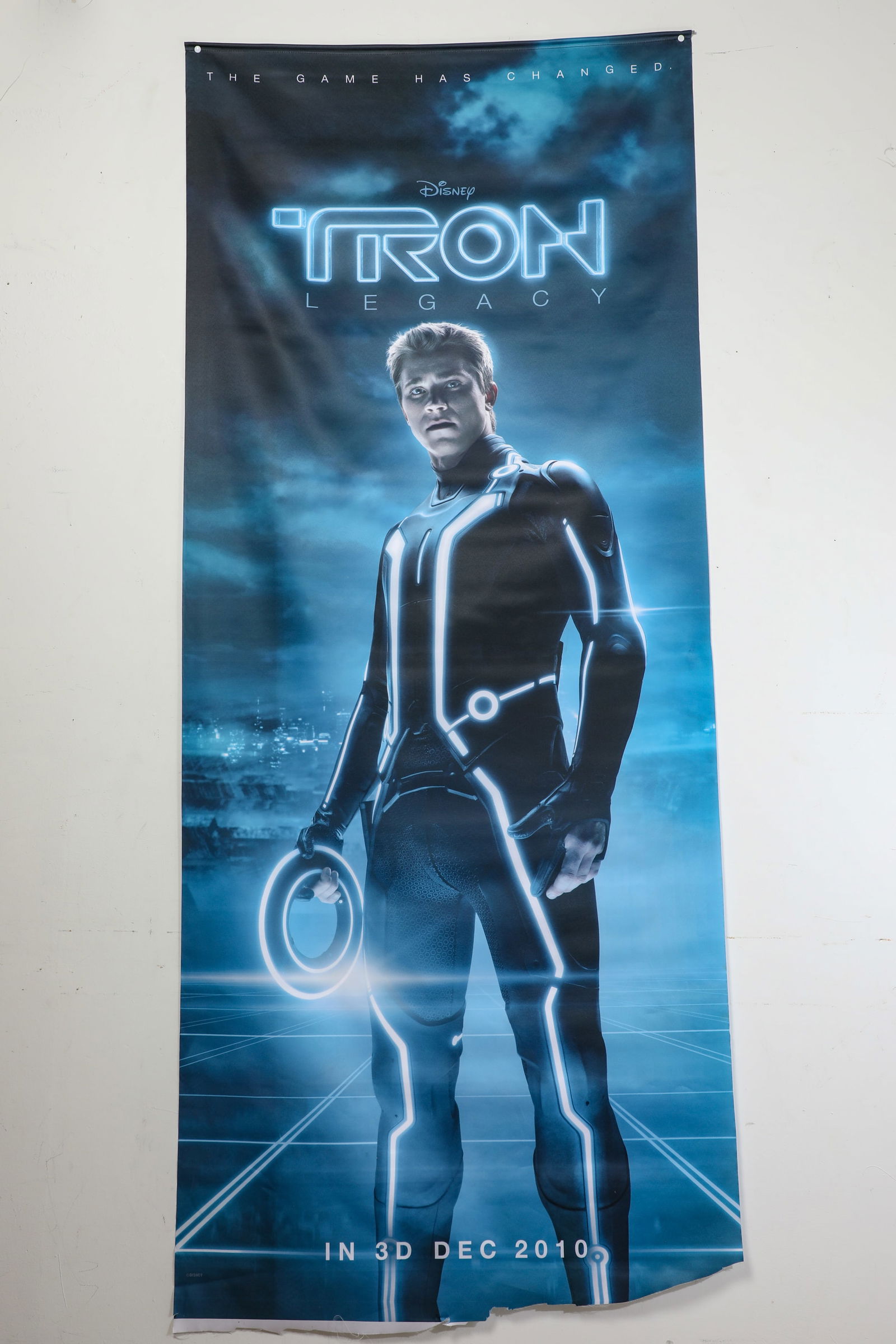 Tron Legacy Promotional Banner.: (Disney, 2010) This is a massive promotional fabric banner for Tron Legacy. Featuring Garrett Hedlund as Sam Flynn, the 78" x 33" banner features the slogan "The Game Has Changed." The banner was used