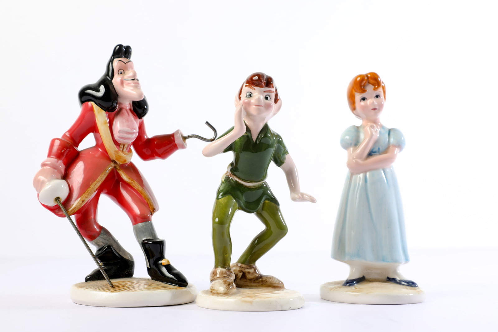Peter Pan, Wendy & Captain Hook Porcelain Figurine Set (1990s).: “Now, think of the happiest things.” Captain Hook, Wendy Darling, and Peter Pan are recreated in delicate, hand-painted porcelain for this (3) figure tribute to Walt Disney’s Peter Pan! Meas