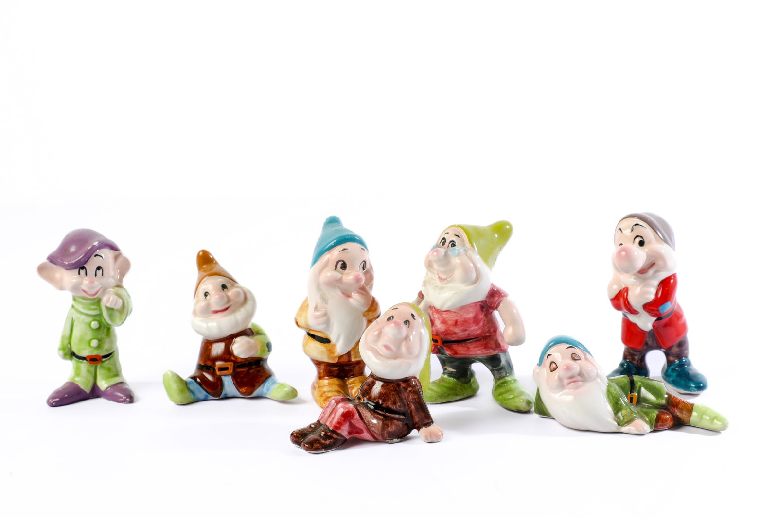 Seven Dwarfs Porcelain Figurine Set (1980s).: “Heigh-Ho!” The Seven Dwarfs are recreated in delicate, hand-painted porcelain for this (7) figure tribute to the namesake characters of Walt Disney’s Snow White and the Seven Dwarfs! Includ