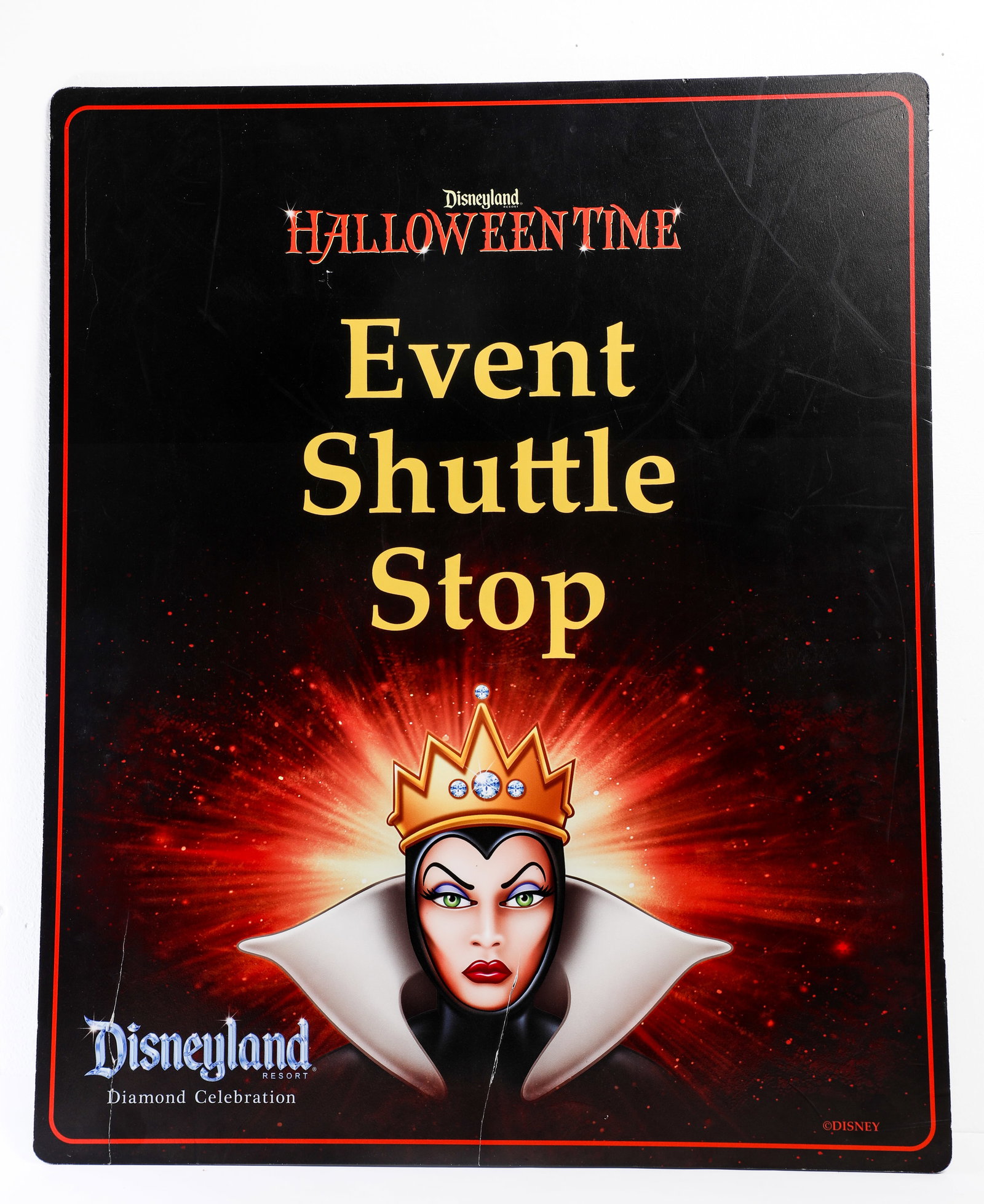 Disneyland - Diamond Celebration Evil Queen “Event Shuttle Stop” Plaque Sign (2015): “Get ready to be dazzled!” The Evil Queen steps out in her finest diamond-studded crown for this plaque promoting a Halloween Time “Event Shuttle Stop” at the Disneyland Resort 60th An