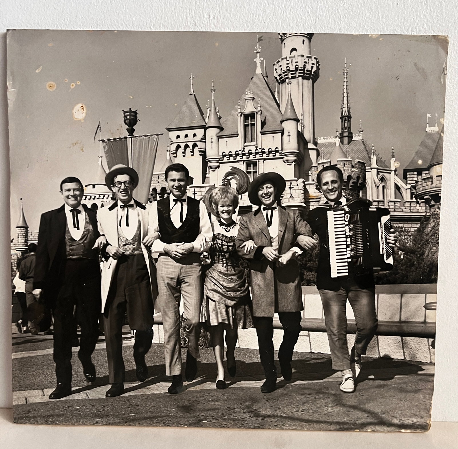 Disneyland - Wally Boag & Golden Horseshoe Cast Backstage Display (1960s).: Rootin’, tootin’ fun when the Wild West comes to Disneyland!” Wally Boag, Betty Taylor, Fulton Burley and the cast of the Golden Horseshoe Revue pose for a mid-1960s promotional photo near S