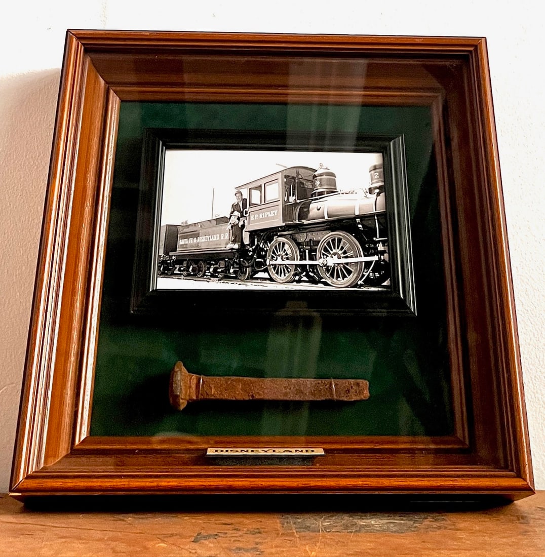 Disneyland Railroad Spike Framed Display (Walt Disney, 1955/2000s): “All aboard” for this exceptionally rare railroad spike, which was originally forged for the Disneyland Railroad! Walt Disney's love for trains was evident in all areas of his life, from his b