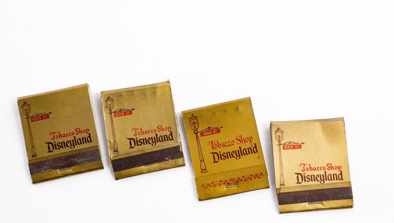 Disneyland - Set of (4) Main Street Tobacco Shop Matchbooks (1960s-1990s): This set of (4) souvenir matchbooks served as conversation pieces of the bygone Tobacco Shop on Main Street U.S.A. at Disneyland! Each of the double-sided matchbooks feature graphics of Main Street U.