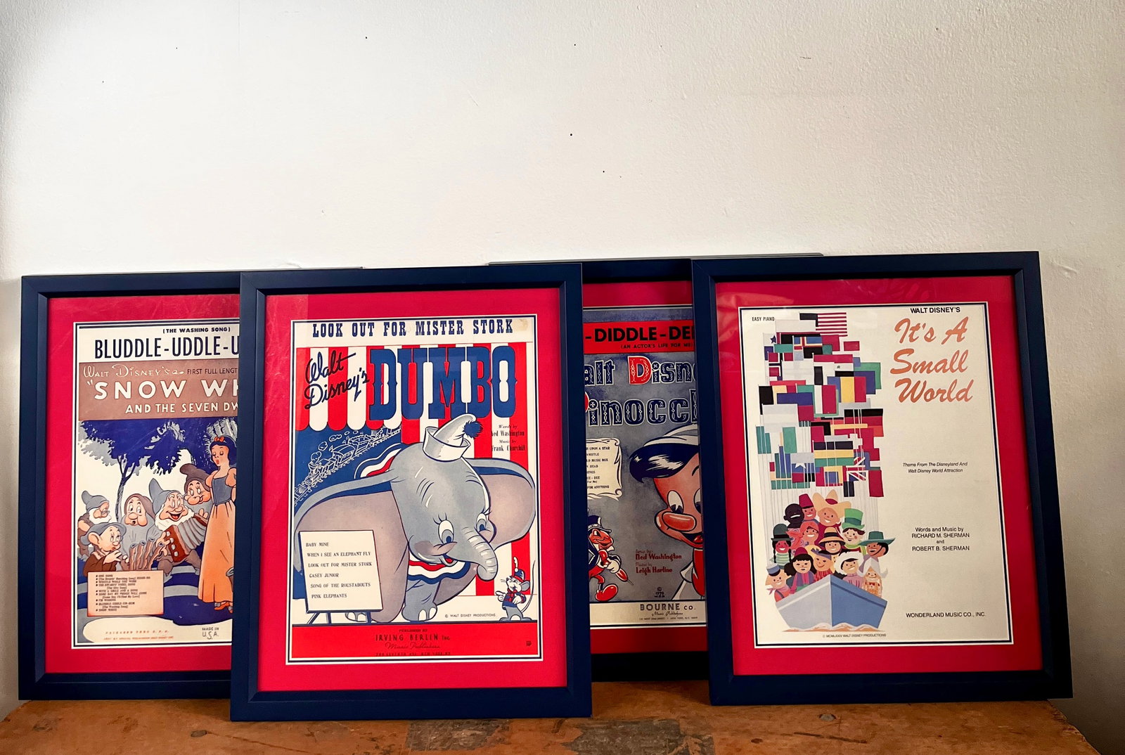 Group of 4 Framed Vintage Disney Sheet Music Displays.: (Disney, c. 1940s-60s) This is a very rare offering of 4 vintage Disney sheet music displays that have been custom framed. These display-worthy artifacts of Disney history feature beautiful illustrati
