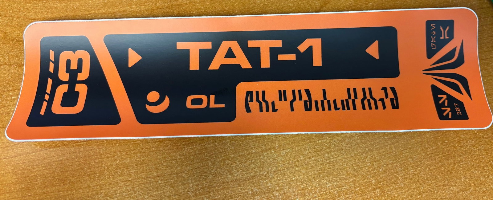 “Disneyland - Star Tours - The Adventures Continue Droid Customs Label Prop (2011-2020s): This style of bright orange, prop label is affixed to a shipping crate containing GNK power droid, within the Droid Customs Room of the updated Star Tours: The Adventures Continue (2011)! The code “