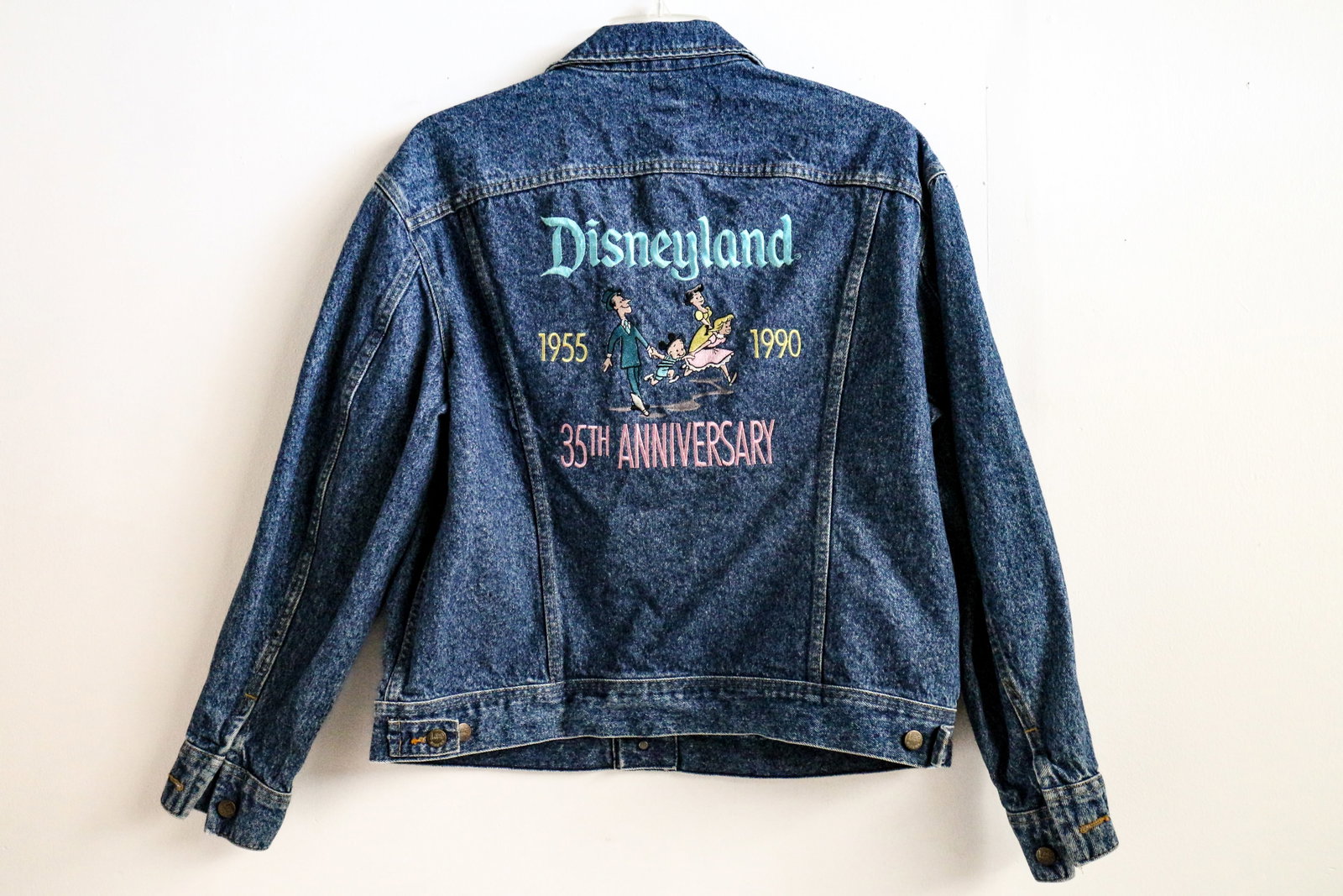 Disneyland Cast Exclusive “35th Anniversary” Lee Denim Jacket (Disney, 1990): “Here, age relives fond memories of the past.” A fabulous family of four prepares for a fun-filled day, on this commemorative, Disneyland Cast Exclusive “35th Anniversary” Jacket from 