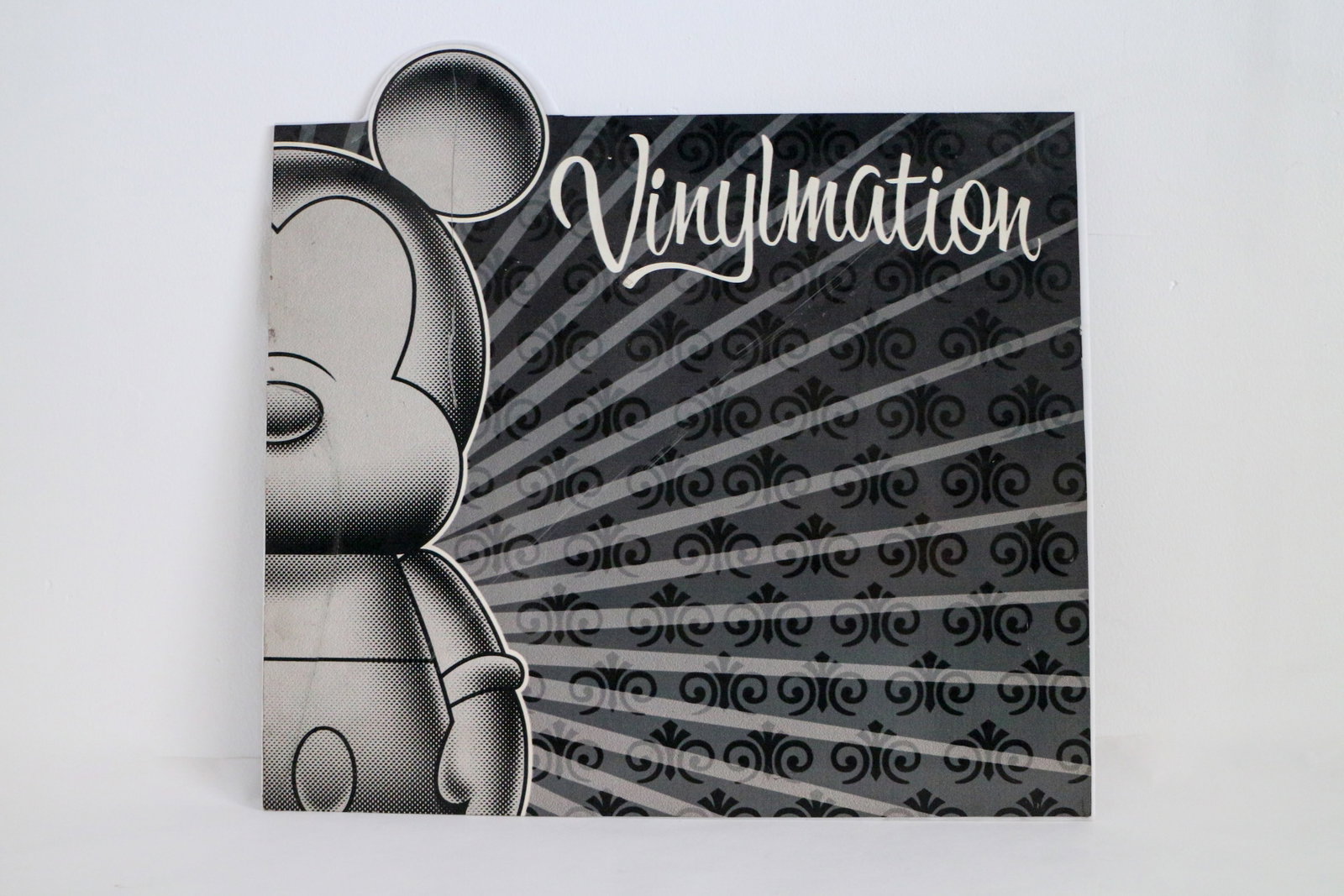 Disney Vinylmation Store Display Plaque (c. 2008-2018): The iconic Mickey Mouse towers over each side of this original store display for Disney Vinylmation! Disney Vinylmation figures (2008-2018) were a line of blind-box collectibles which featured Mickey 