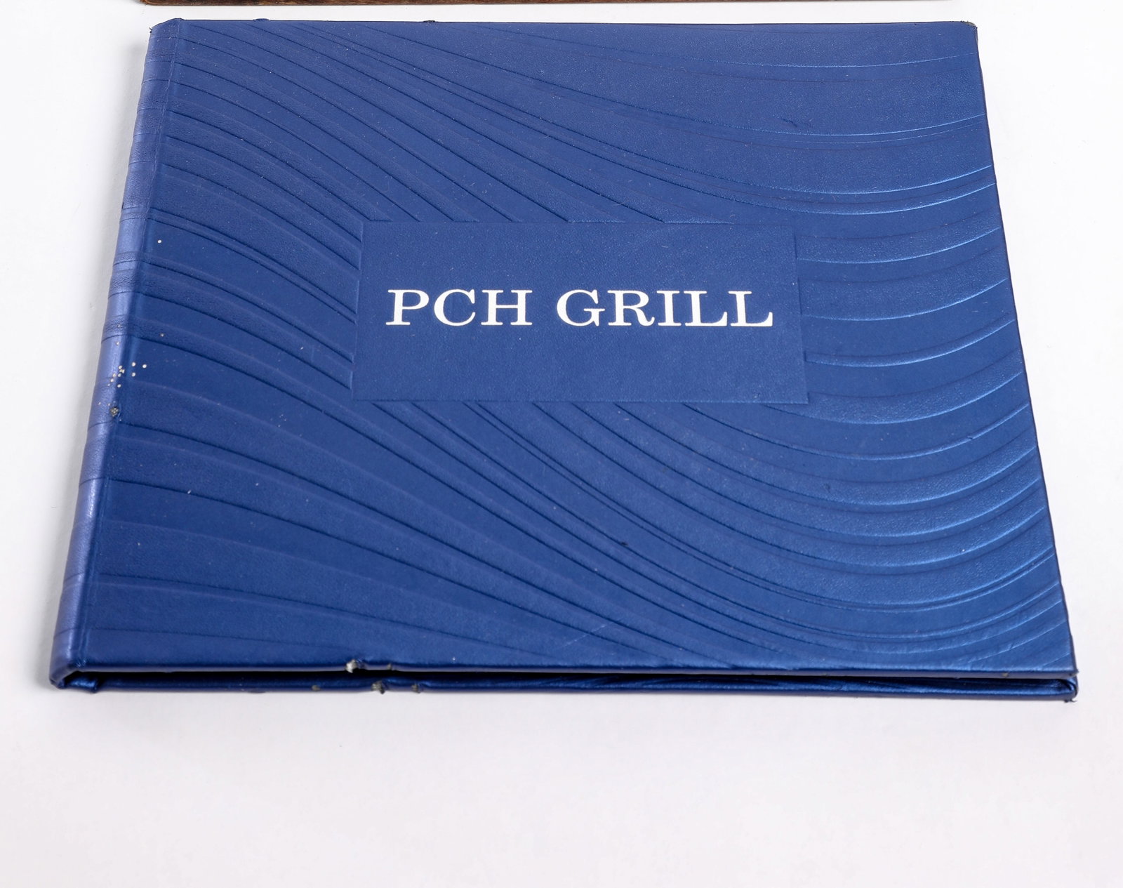 Disneyland - Paradise Pier Hotel PCH Grill Menu Cover (2000-2020): “Surf’s up” with this retro menu from PCH Grill in Paradise Pier Hotel at Disneyland Resort! For 20 years, PCH Grill captured the relaxed essence of California’s scenic state route - Pacif