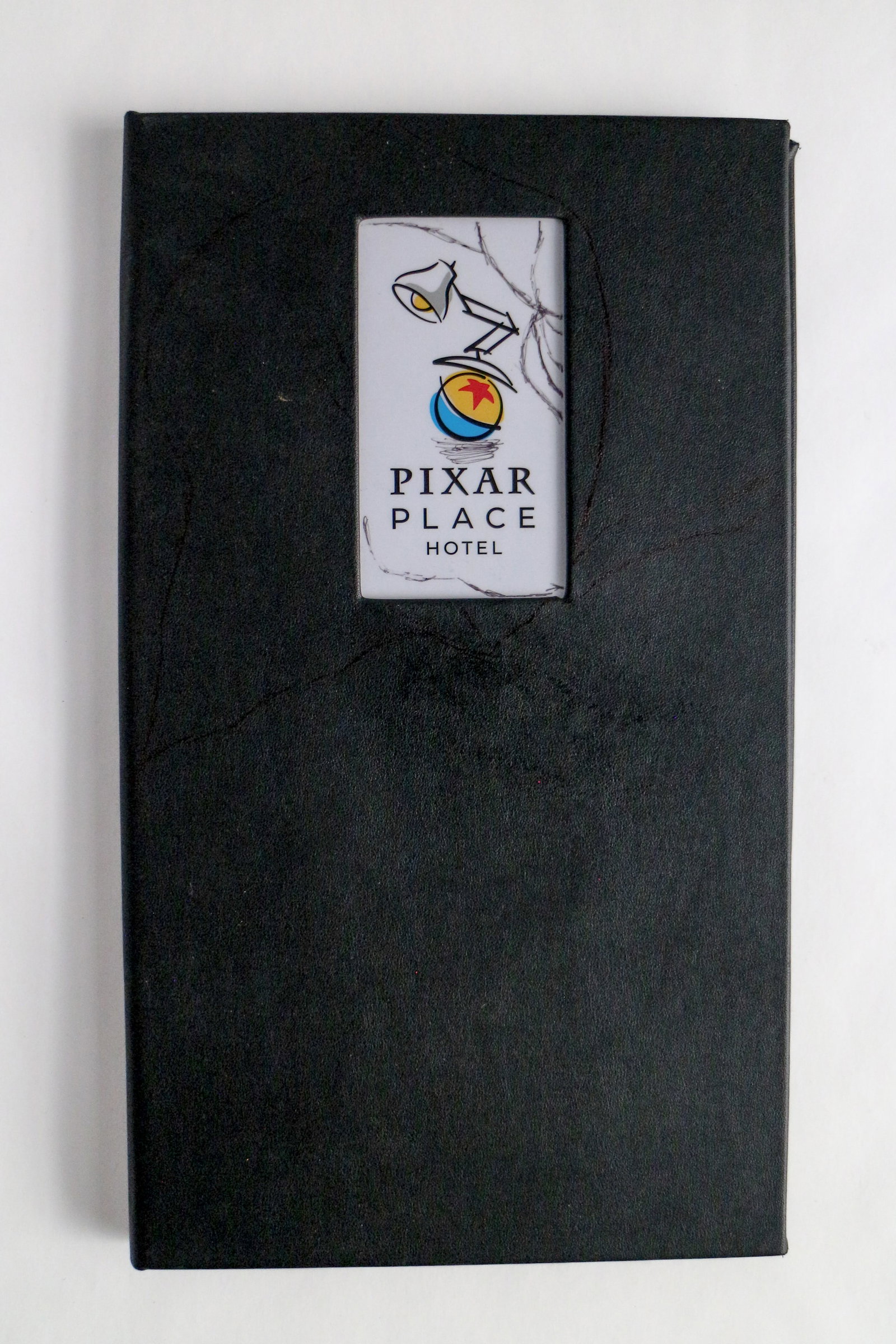 Disney California Adventure - Pixar Place Guest “Welcome” Information Folder Cover (2022).: Ambassadors Luxo, Jr. (and his familiar little ball) are the stars of this authentic materials binder, introducing guests to Pixar Place Hotel at Disneyland Resort! In 2022, Disney’s Paradise Pier H