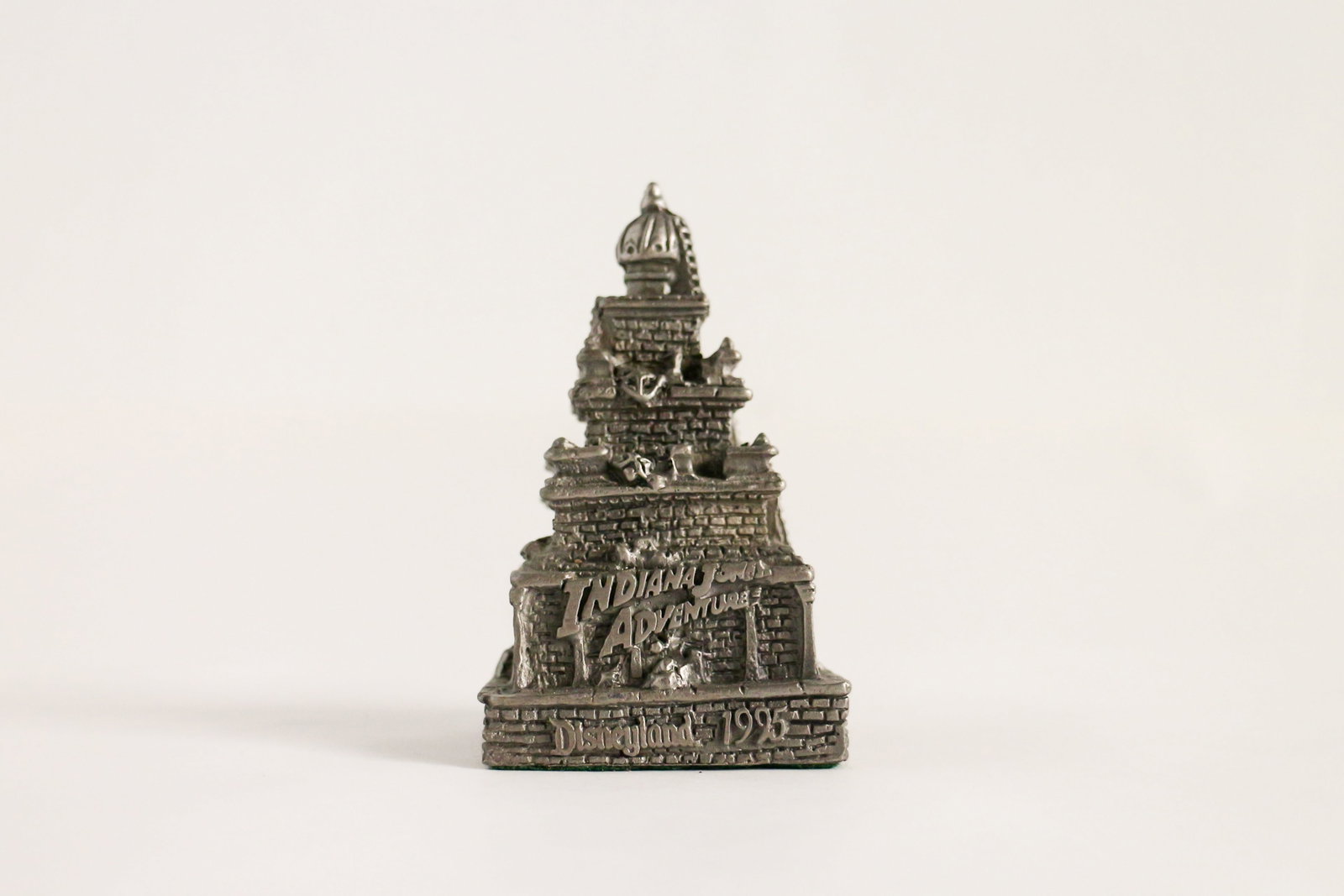 Disneyland - Indiana Jones Adventure Pewter Press Gift (Disney, 1995): From “the remote jungles of India’s Lost Delta”, this small souvenir paperweight commemorates the pre-opening press event for the Indiana Jones Adventure: Temple of the Forbidden Eye at