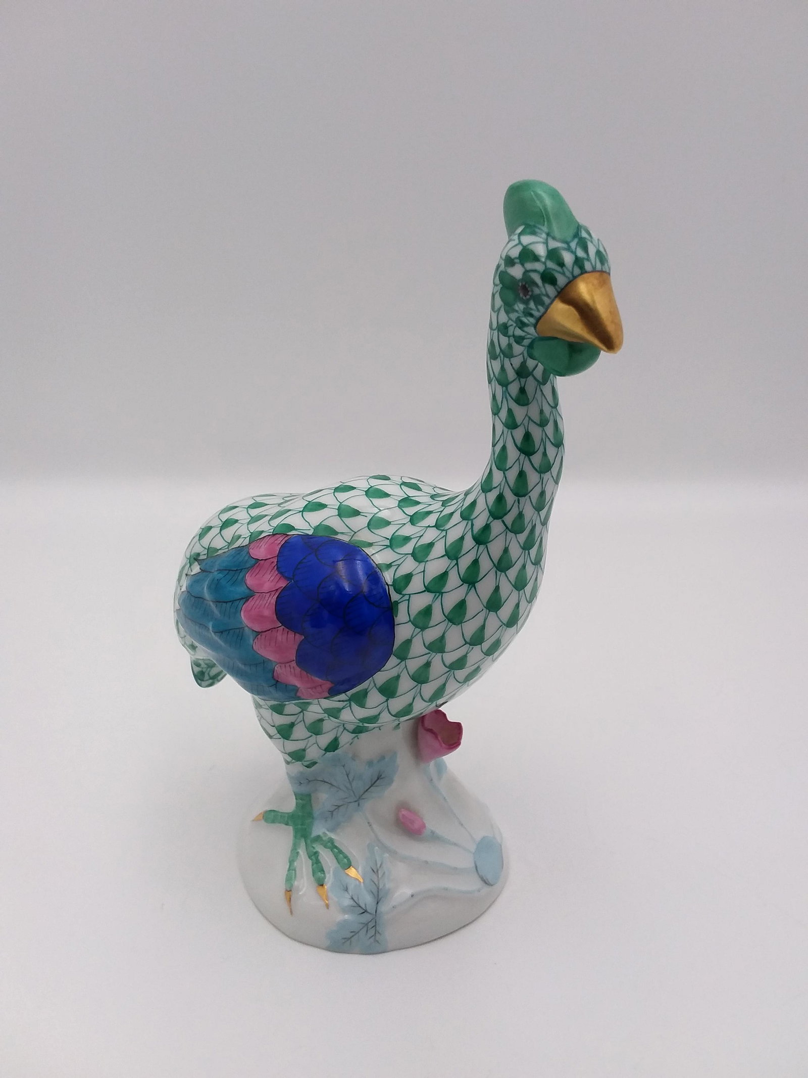 Herend Guinea Fowl Fishnet Pattern Figurine: Guinea Fowl by Herend hand painted with a green fishnet throughout, bright colored feathers for wings and tail, beak is painted in 24K gold.