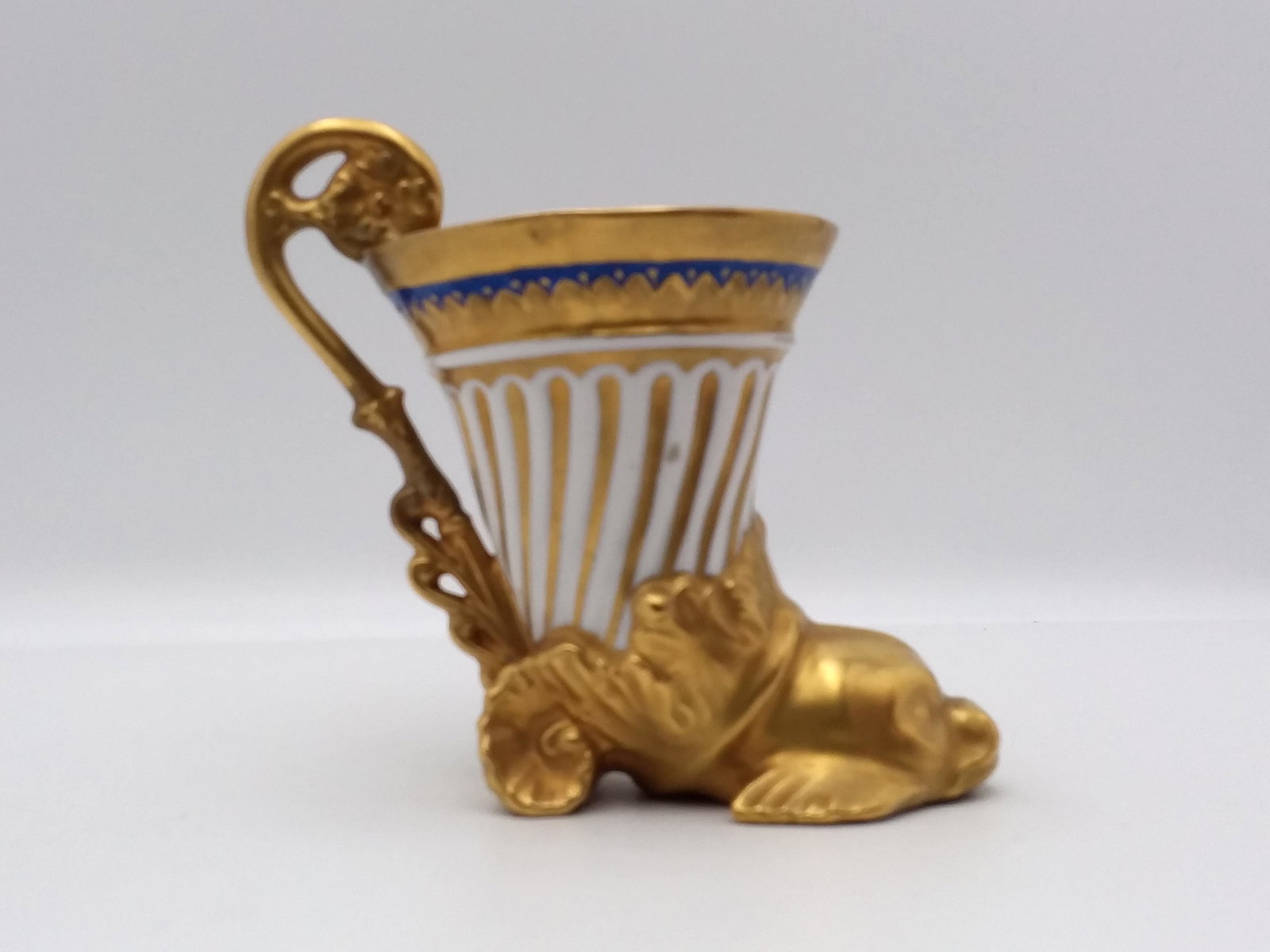 Antique Sevres Gold Encrusted Dolphin Shaped Cup: Hand painted Gold, blue, & White Dolphin Shaped Sevres Cup, hallmarks could be observed on the underside of the cup