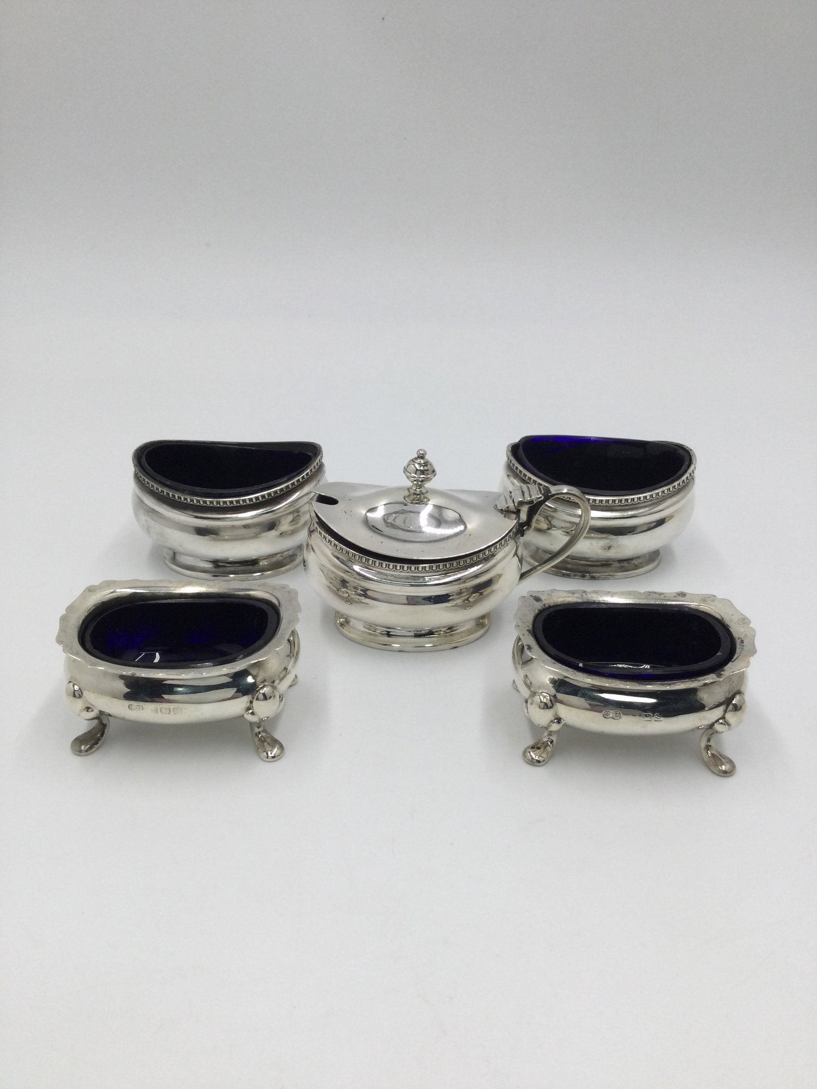 Adie Bros. England Sterling Silver Salt Cellar Set: Adie Bros. England Sterling Silver Salt Cellar Set & Mustard Pot with Cobalt inserts. Hallmark: Adie Bros England, Size: 1 1/4" h x 2 1/4" W x 1 3/4" L. Approximately 54.4 Grams. Free pick-up at our w