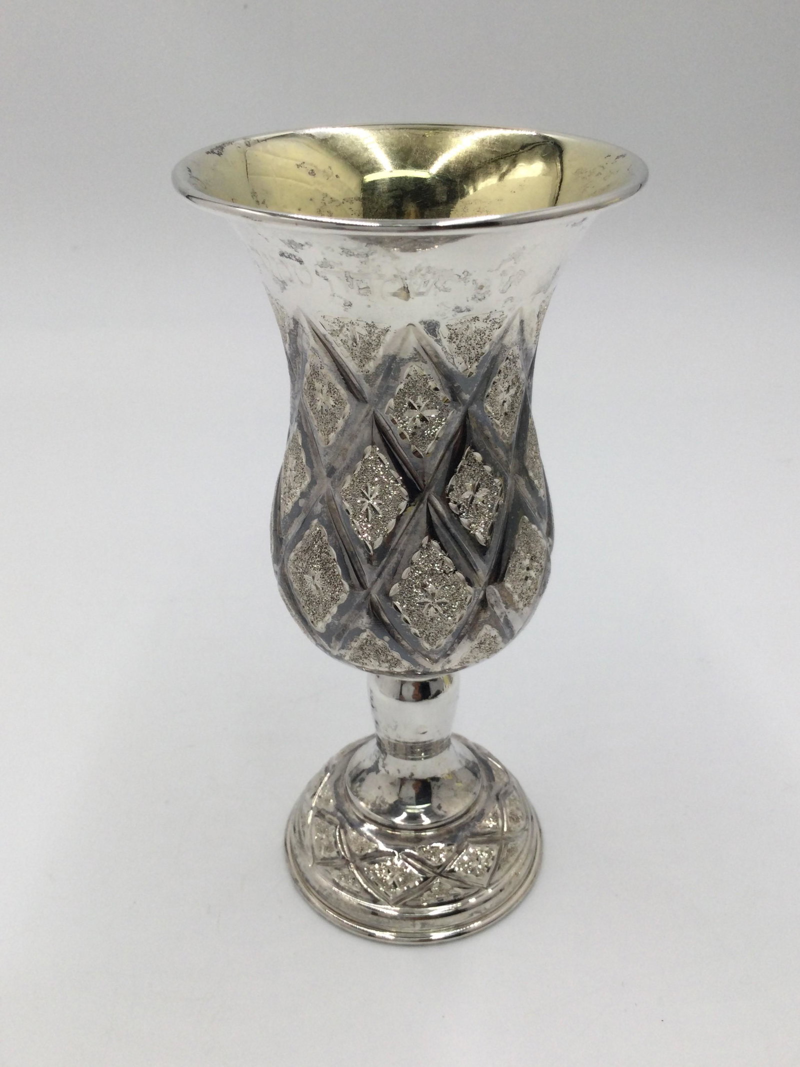 Sterling Silver Kiddush Cup: Sterling Silver Kiddush Cup, Fancy Diamond Pattern. Approximately 121.8 grams, Size 6 inches Tall x 2.75 inches across the mouth.Shipping is done by a 3rd party shipper and will be invoiced separately