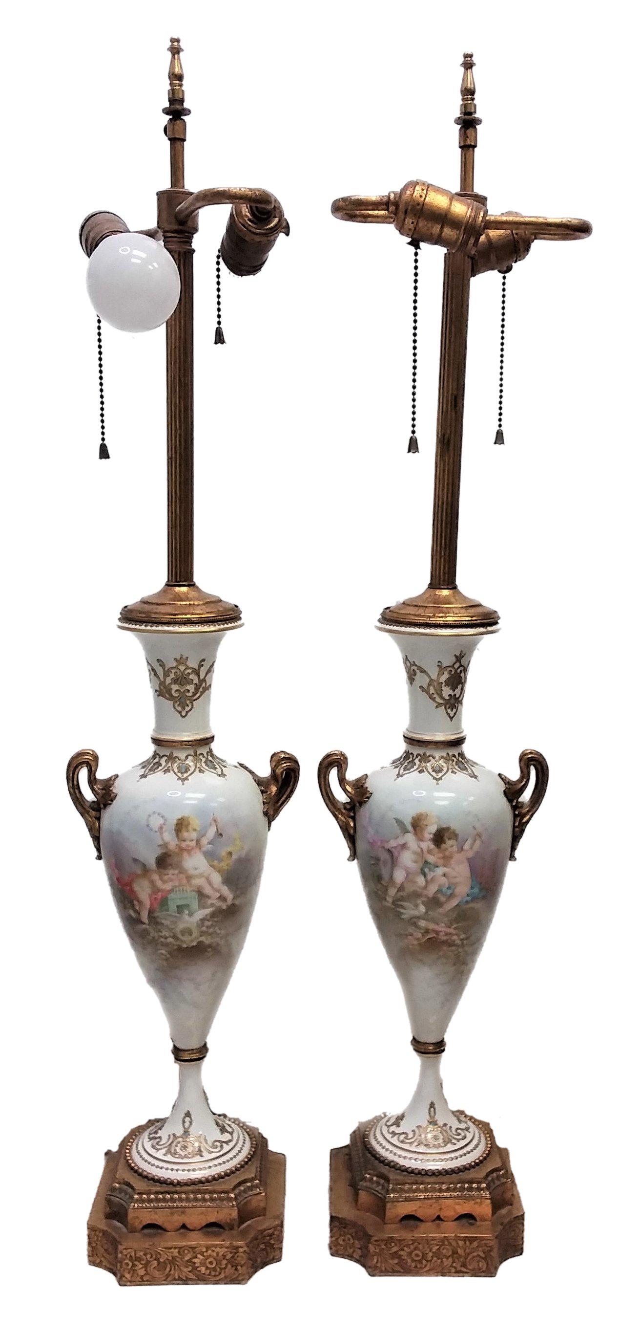 Antique Pair of Sevres Quality Lamps Signed A. Callot: Antique Pair of Sevres Quality Hand Painted Porcelain Lamps Depecting Angels, signed A. Callot. Measuring approx. 33.75 finial to base x 7 inches wide handle to handle, weight 14.8 pounds. For Shippin