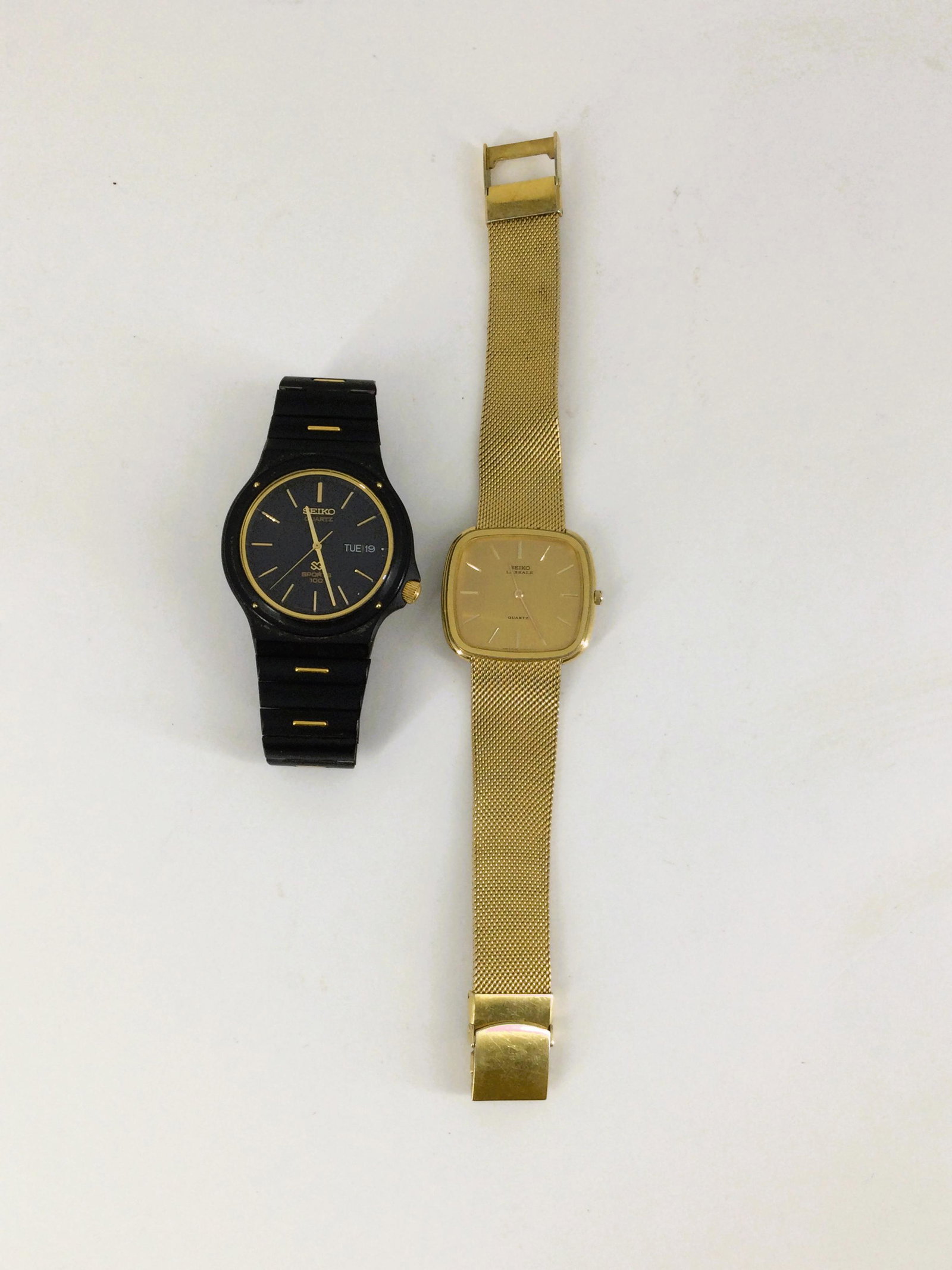 Men Lot of Two Seiko Watches: Black Seiko SQ Sports 100. Face Approx. 1.5 inches, 7 inch long. Seiko Lassale 6020-5029 R approx. 1.25 square, 8 inch. Combined weight is a total weight 4 oz. IMPORTANT: In House Shipping.