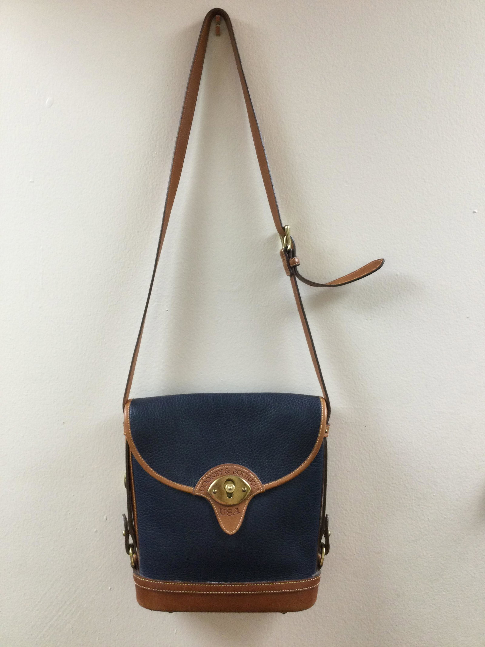 Vintage Dooney & Bourke Blue and Tan Leather Shoulder Bag: Vintage Dooney & Bourke Blue and Tan Leather Shoulder Bag. Approx. size 10.25 inches tall x 9 wide x 3 deep. Adjustable strap. Approx. weight 2 lbs. IMPORTANT: In House Shipping.