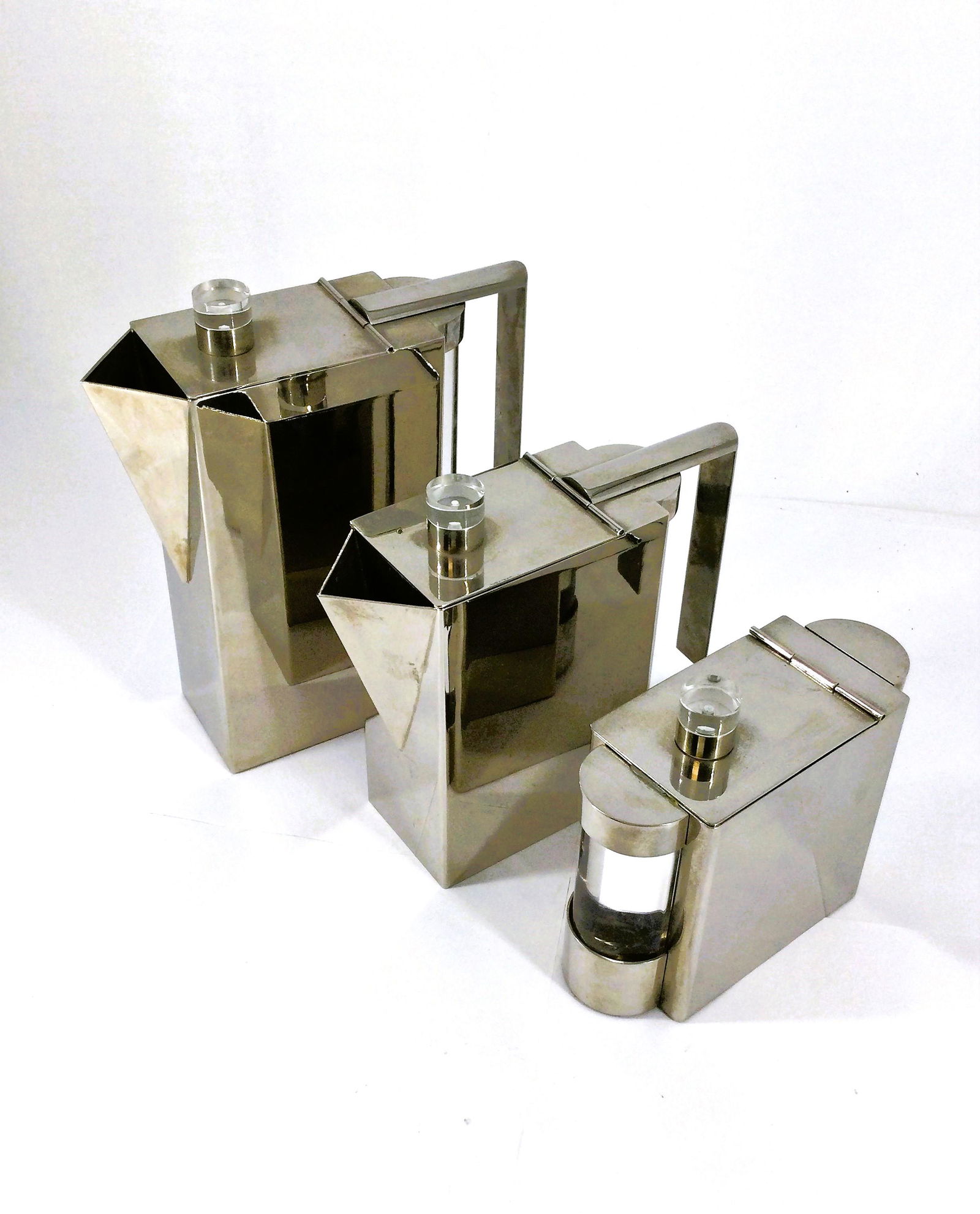 Italian Montagnani Steel and Lucite Tea Set: High quality tea service set designed by Punto Bacola for Montagnani of Florence, Italy, circa 1980. Formed of sculptural polished steel with Lucite side/end caps and finials. Marked with gold label -