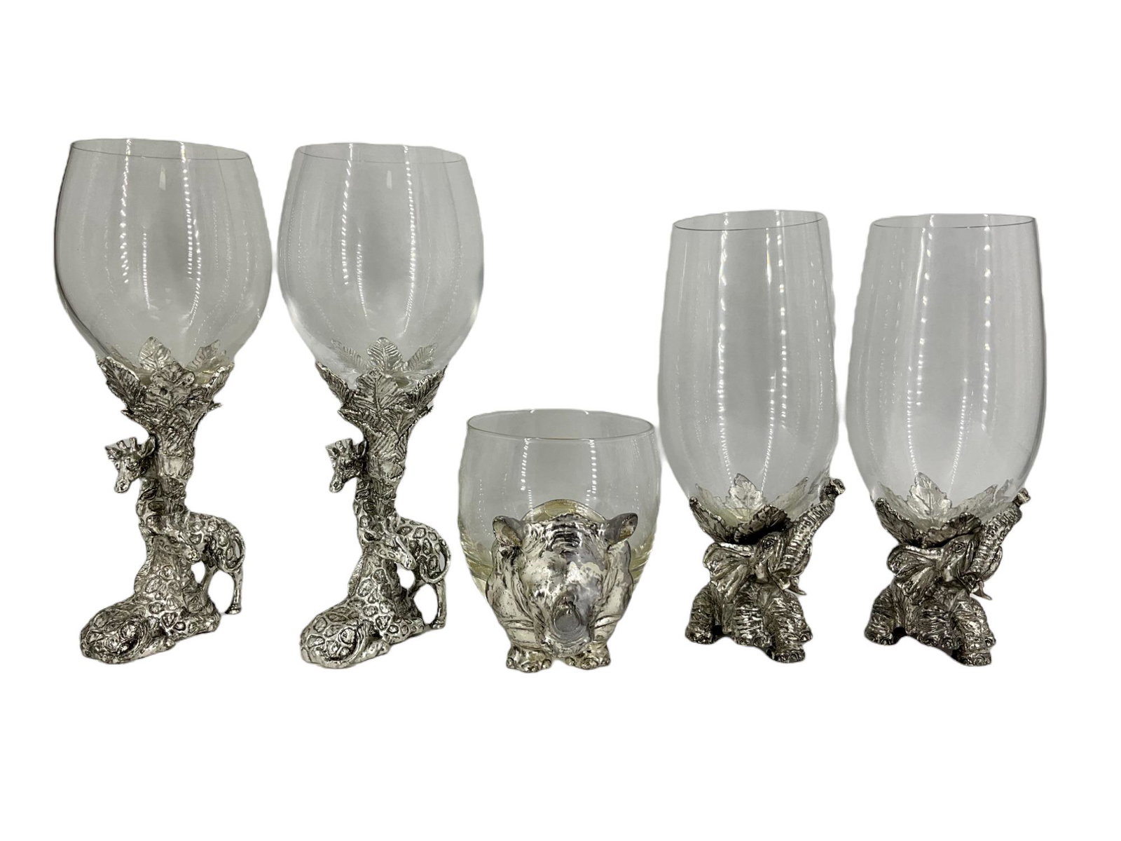 Lot of 5 Arthur Court Glassware: Lot of 5 Arthur Court Glassware. 2, wine glasses with giraffes under a tree holding up the glass. 2, iced tea glasses being held up by baby elephants. 1, scotch glass incorporated into a rhino. Approx