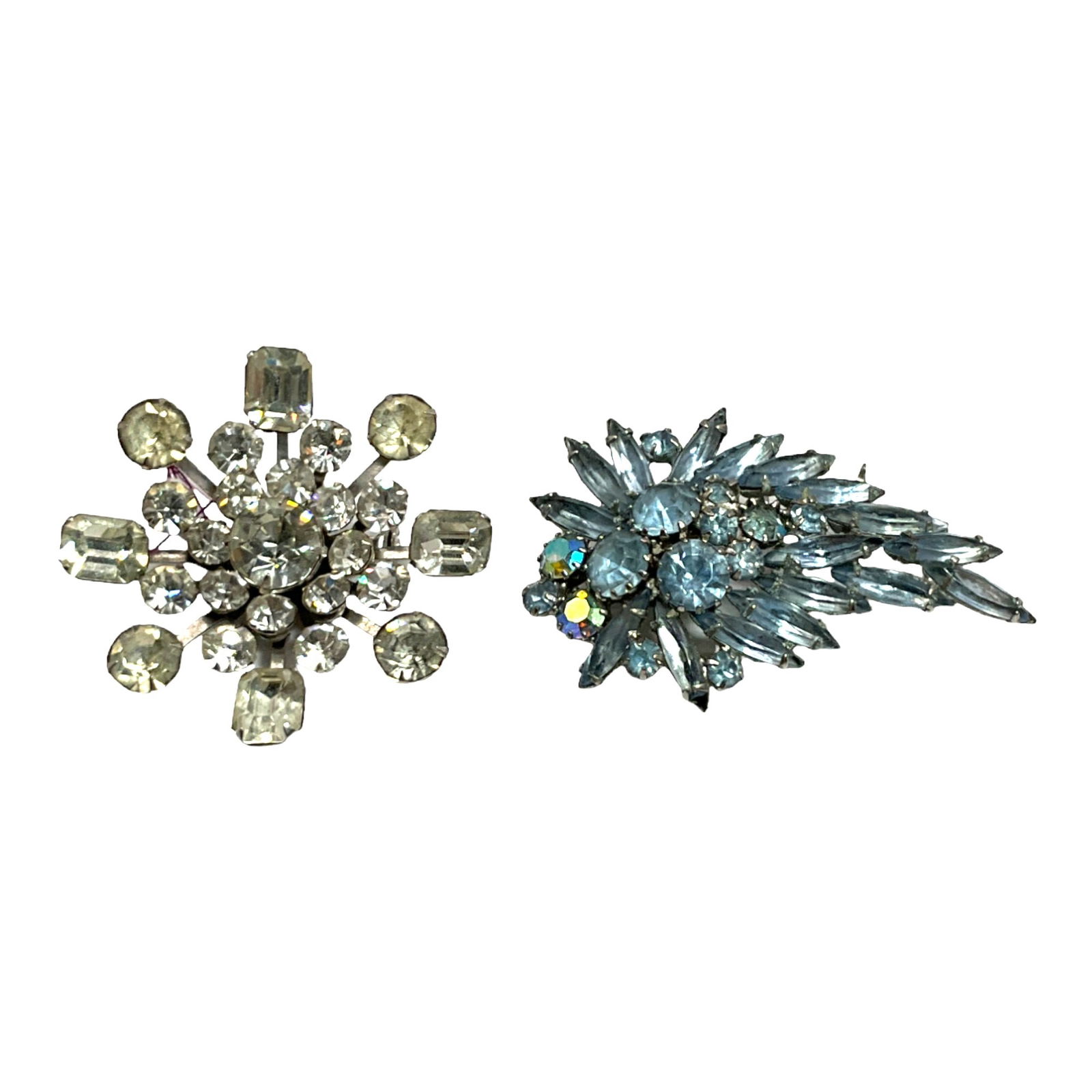 Vintage Lot of 2 Rhinestone Brooches, one by Coro: Vintage 2 Rhinestone Brooches, Coro Clear Rhinestone Flower, and Unsigned Blue Rhinestone Leaf Brooch. Coro Approx. 2 inches round, Leaf approx. 2 1/4 long x 1.5 inches wide.