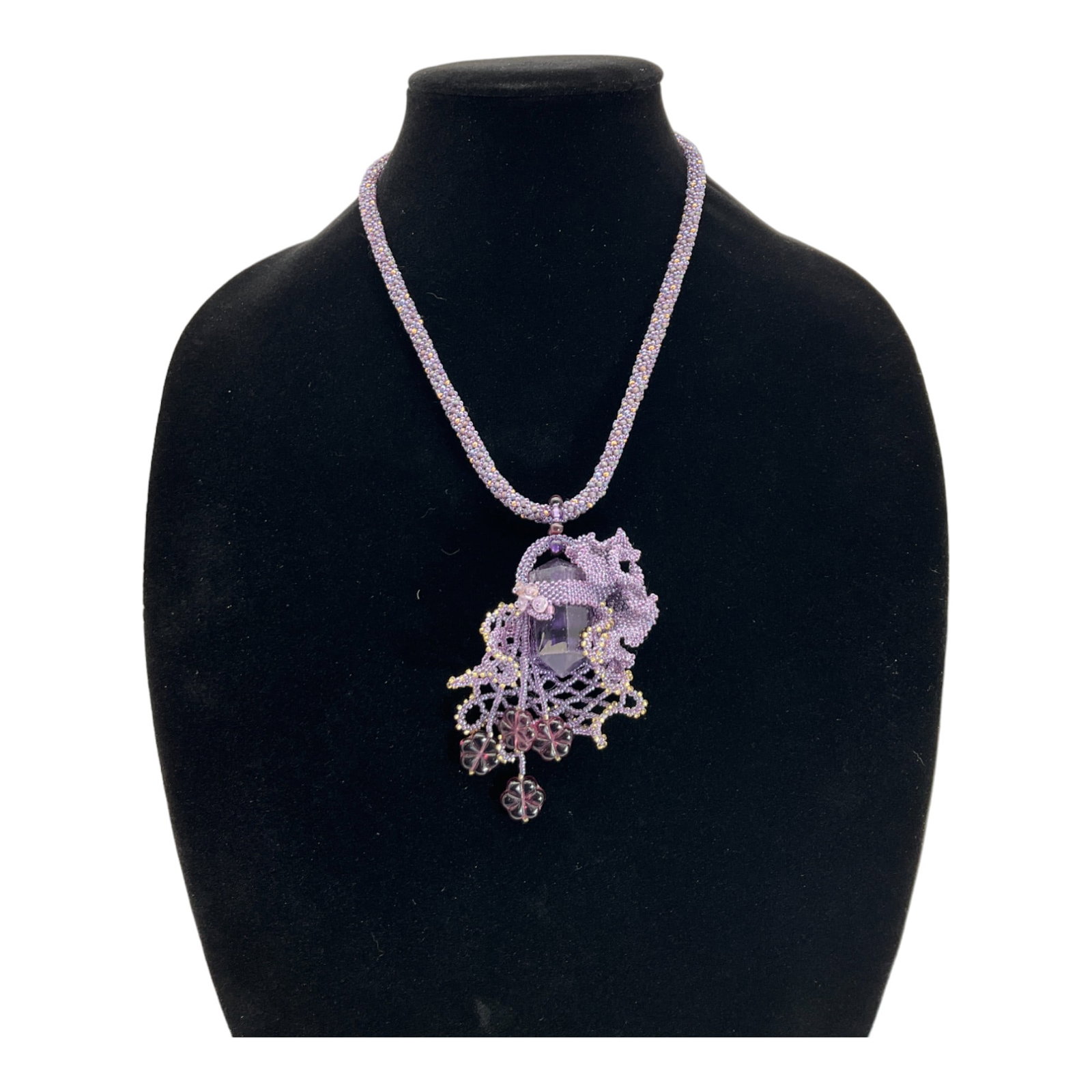 Purple Beaded Necklace with Large Amethyst Pendant: Hand Beaded Purple rope necklace with Large Center Faceted Amethyst. Approx. 23 inches long, Pendant is approx. 4 x 2.5 inches.