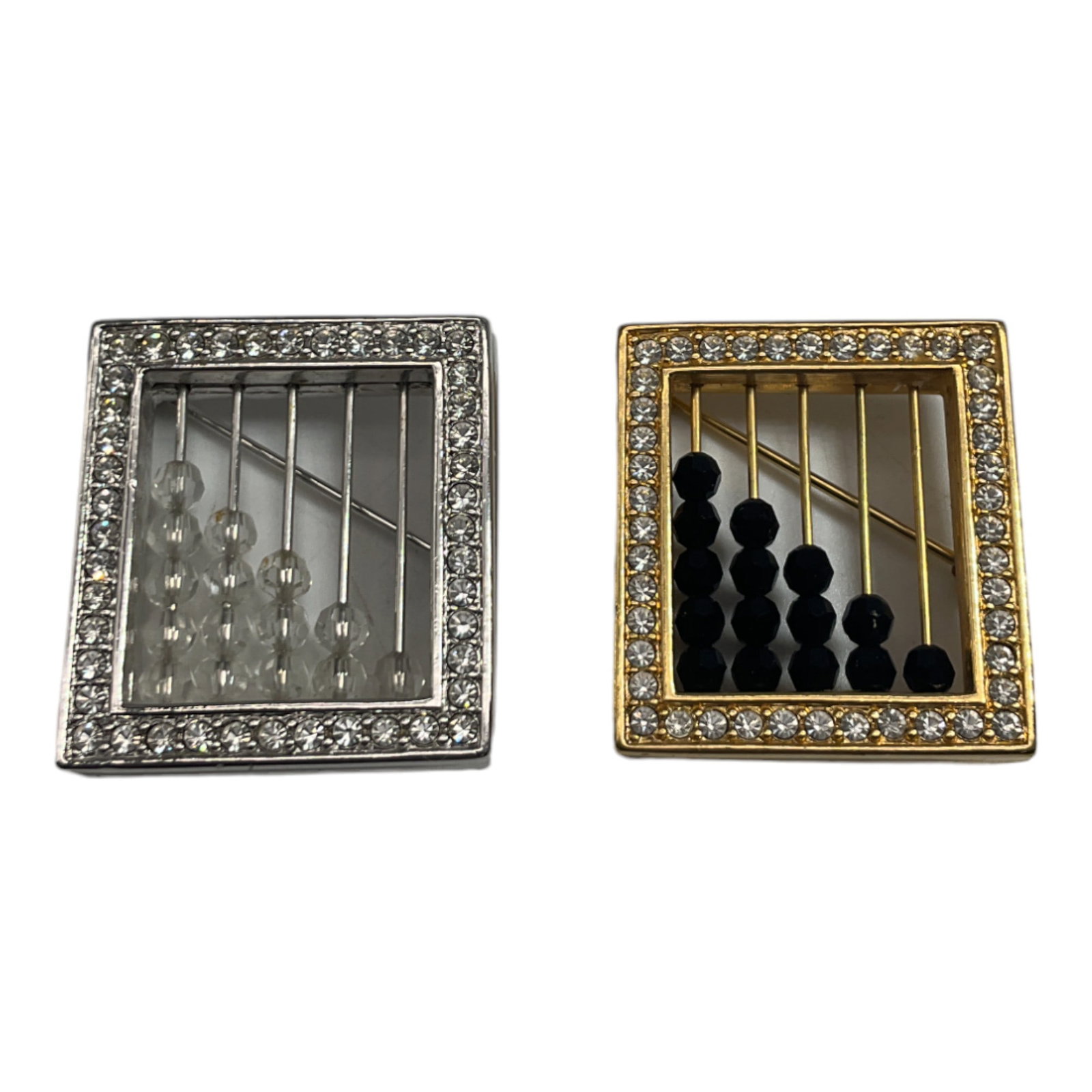 Lot of 2 Swarovski Swan Signed Brooches: Swarovski Abacus Shaped brooches in gold and silver tones, Swan Signed. Approx. 1.25 x 1 each with movable beads.