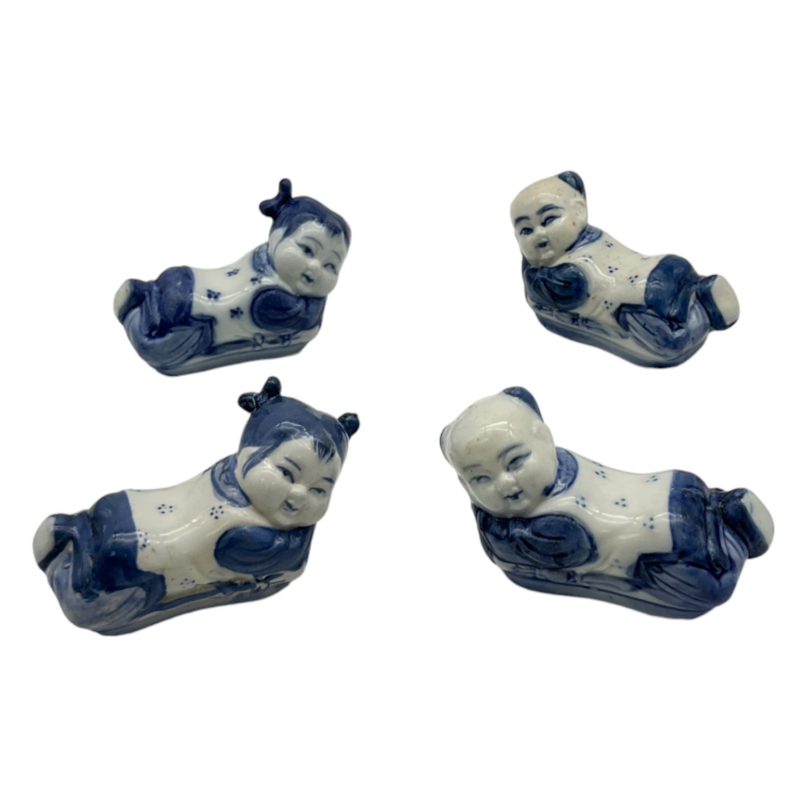 Lot of 4 Opium Pillow Figurines: Lot of 4 Opium Pillow Figurines, 2 boys and 2 girls laying down. Porcelain opium pillows were made to feel cool when laying down.Approx. 2 tall x 3 wide x 1.25 deep inches, 7 oz.