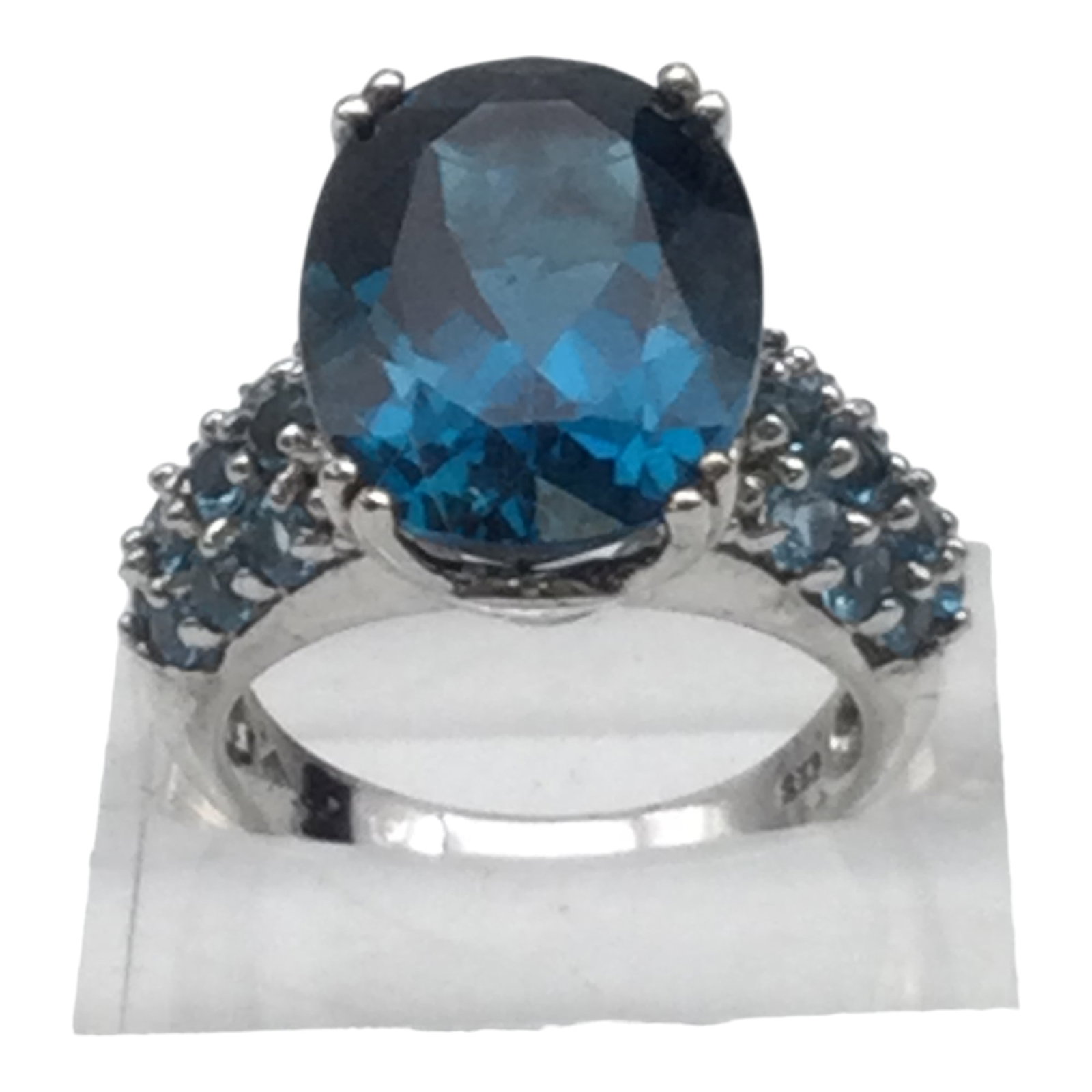 Signed Blue Topaz Cocktail Ring Sz. 7: London Blue Topaz Cocktail Ring, Signed and Stamped 925, Size 7. Excellent Pre-owned condition with no missing stones and minimal wear.