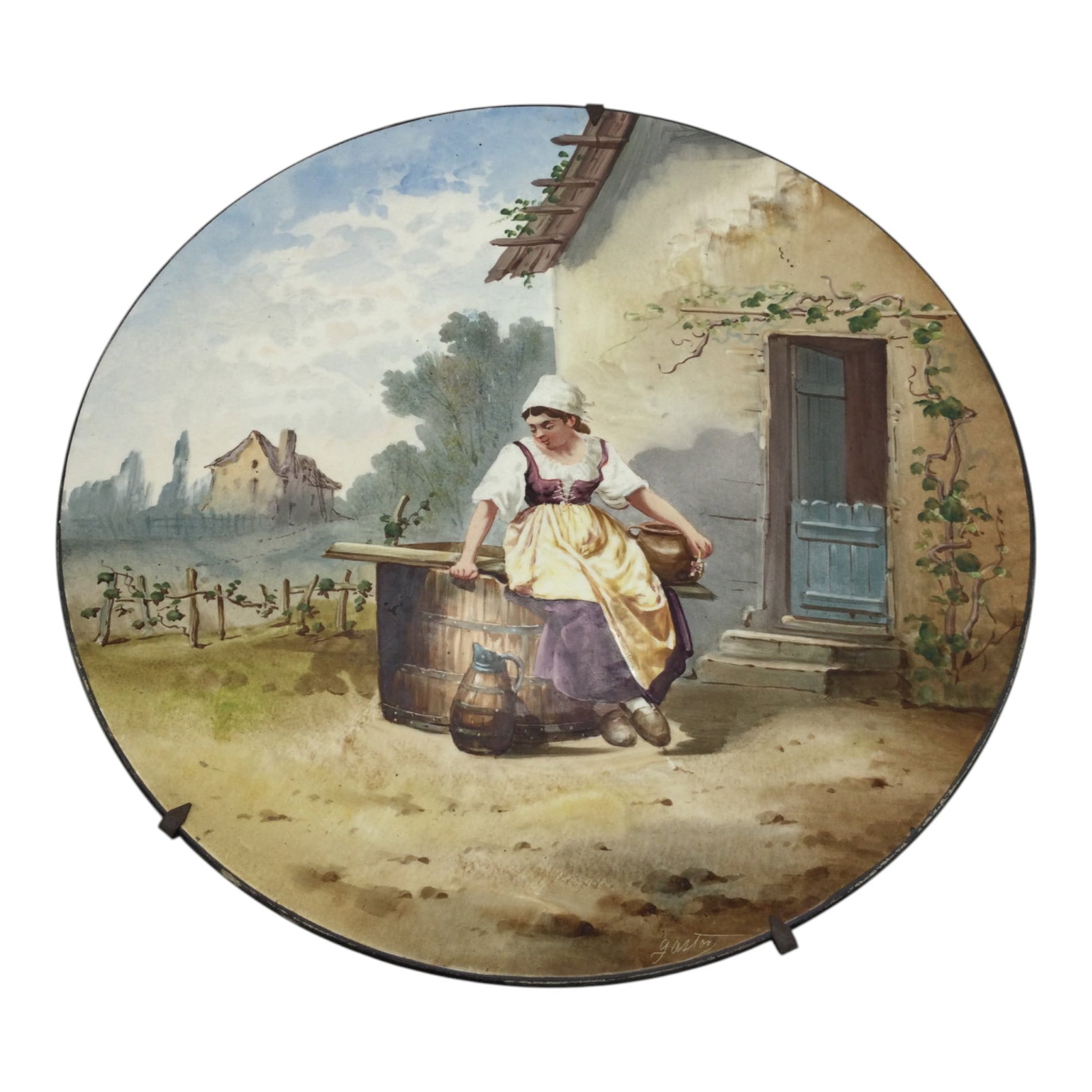 Signed French Hand Painted Charger Plate: Gaston Signed French Hand Painted Charger Plate depicting a girl sitting on a barrel at a vineyard. Approx. 13 inches across. 2.1 lbs.