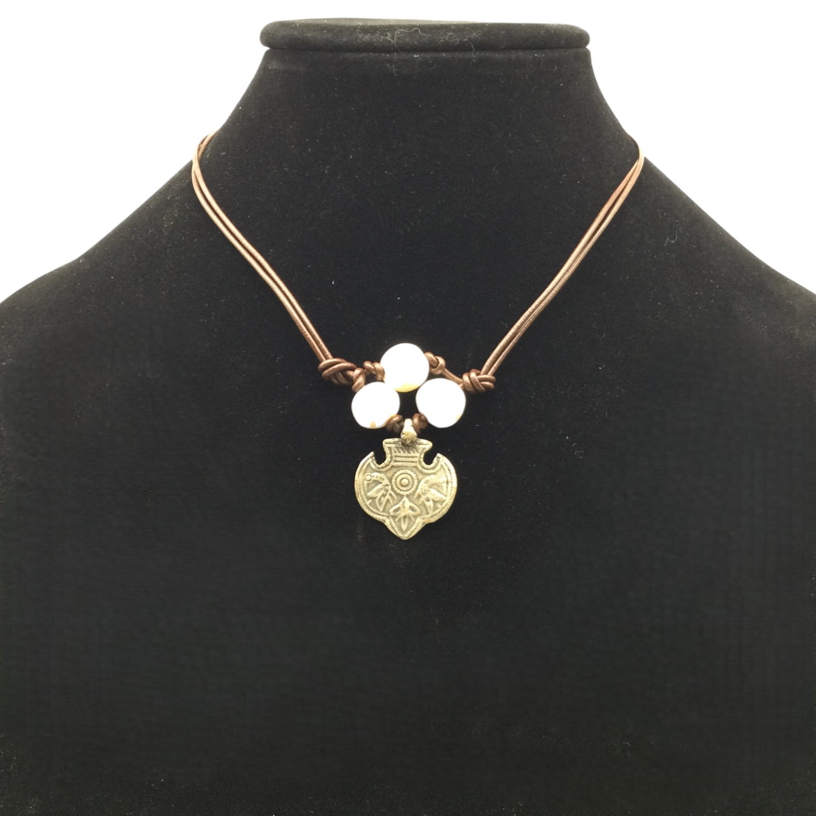 IN2 Sweden Pearl and Leather Necklace.: IN2 Pearl and Leather Necklace with press designed metal pendant. Approx. 17 inches end to end, pendant 1 tall x 1 wide.