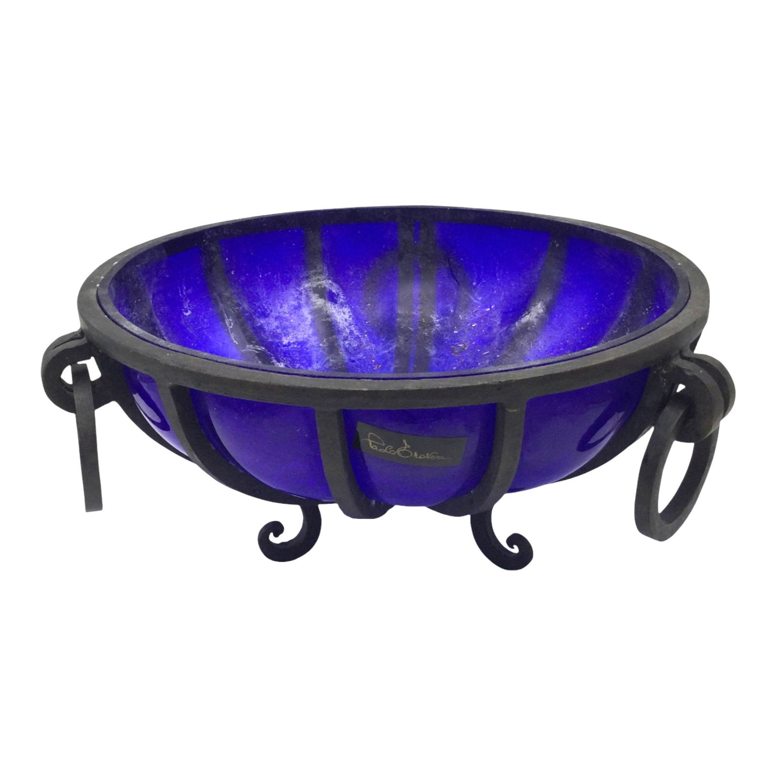 Wrought Iron Caged Art Glass Bowl Signed: Wrought Iron Caged Art Glass Bowl, with a tag that appears to read Paolo Grovers. Approx. 6 inches tall x 12.5 wide x 11.5 deep, 7.3 lbs.