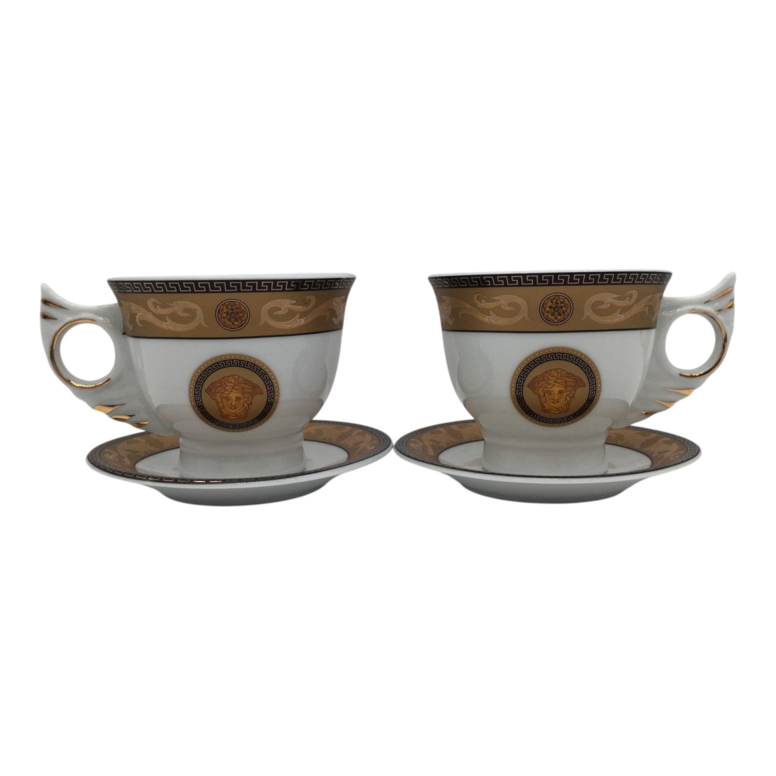 Pair of Medusa Tea Cups: Pair Medusa Tea Cup and Saucers. Approx. 3.5 inches tall x 4.5 across.