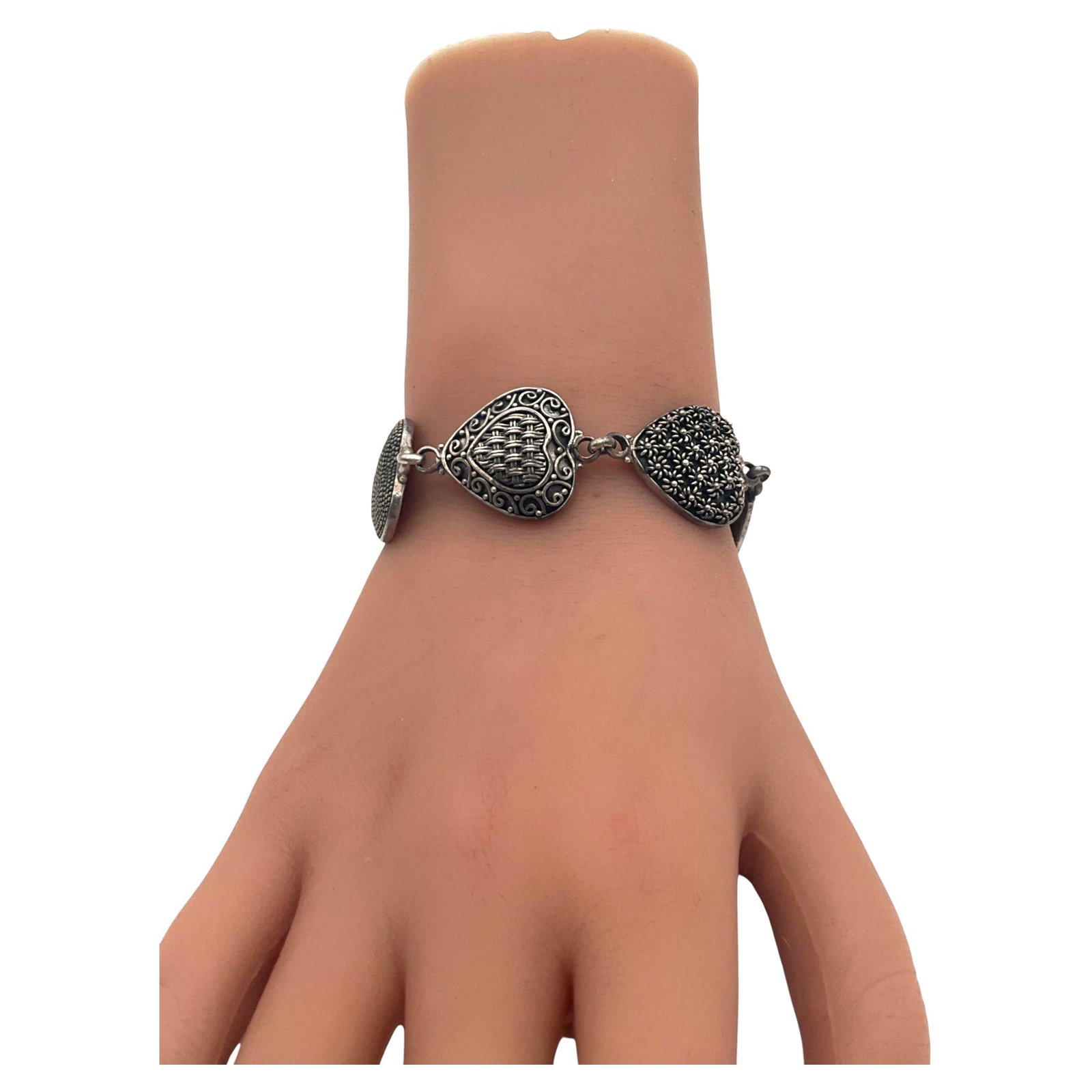 Marked 925 BA Indonesia Sterling Silver Heart Links Bracelet: Marked 925 BA Indonesia Sterling Silver multi-designed heart linked Bracelet. Approx. 7 inches end to end x 1 wide.