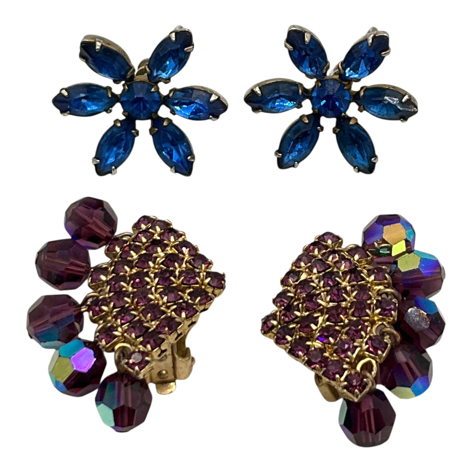 Vintage Lot of 2 Pairs Rhinestone Earrings: Lot of 2 Pair Rhinestone Earrings. Purple with iridescent globe cut dangling on outer side clip-on earrings, Approx. 1.5 inches tall x 1 wide. Blue flower screw back earrings, Approx. 1 across.
