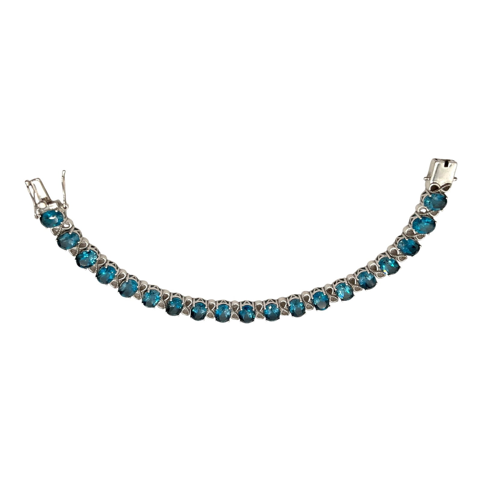 925 Designer Signed Blue Gemstone Tennis Bracelet: Marked SNS 925 India Tennis Bracelet with Blue Topaz gemstones. Approx. 7.25 inches end to end x 0.25 wide