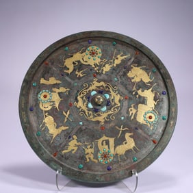 Bronze mirror with inlaid gold and silver inlays of chariots, horses and auspicious beasts from the