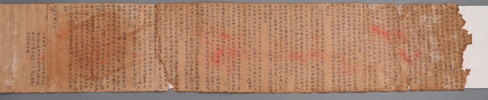 A LONG SCROLL OF THE SUTRA OF AMITABHA BUDDHA WRITTEN IN THE FIFTH YEAR OF GANDE OF THE LIAO DYNASTY: L:138cm(54.33in) W:26cm(10.24in)A precisely-dated ancient Liao Dynasty Buddhist manuscript with complete text and colophons. It possesses profound value of Liao calligraphy art, medieval Buddhist hist