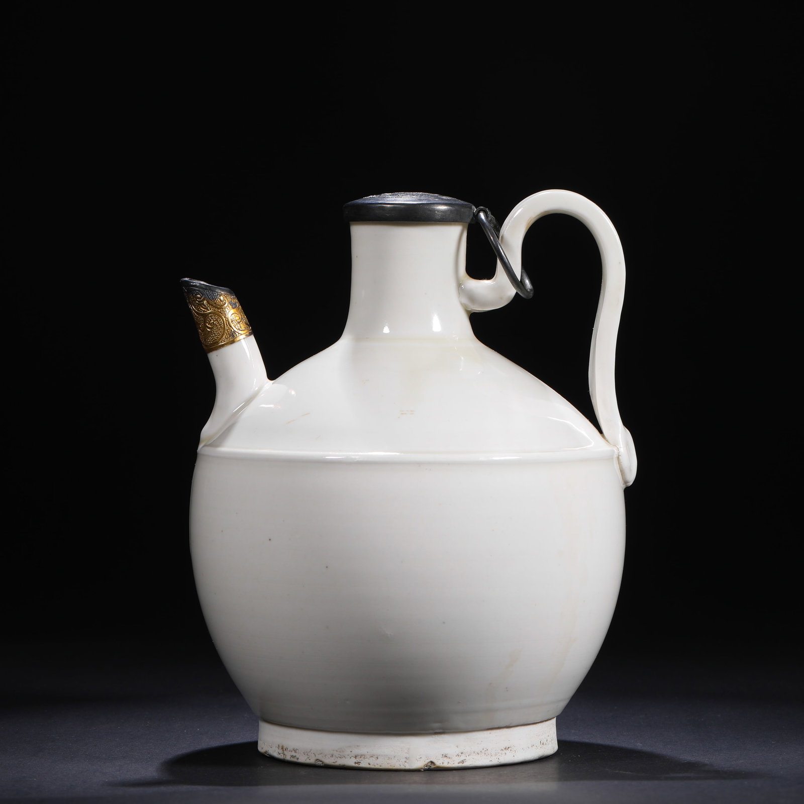 SONG DYNASTY DING KILN WHITE GLAZED EWER: H:18cm(7.09in)W:15cm(5.91in)This Song Dynasty Ding kiln white-glaze ewer, with a pure ivory-white glaze, rounded shape, and later gilded spout and tin lid, is a typical example of northern Chinese whi