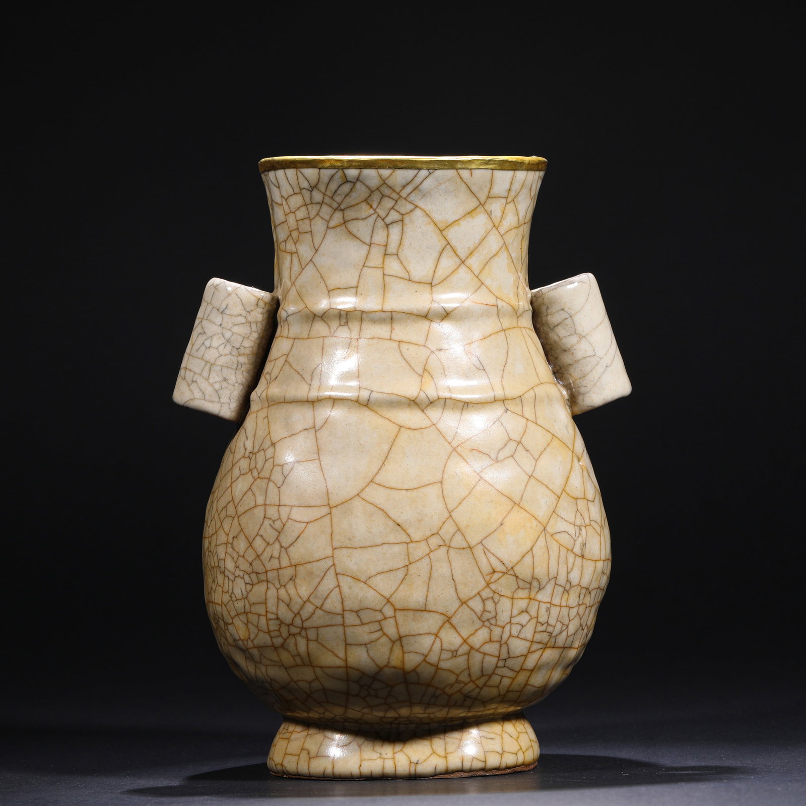 SONG DYNASTY GE KILN BEIGE GLAZED EAR-PIERCING VASE: H:22.5cm(8.86in)W:17cm(6.69in) This Ge kiln rice-yellow glaze guan'er vase, with its warm glaze, intricate "gold wire and iron thread" crackle patterns, and gilded rim, is a typical example of Song