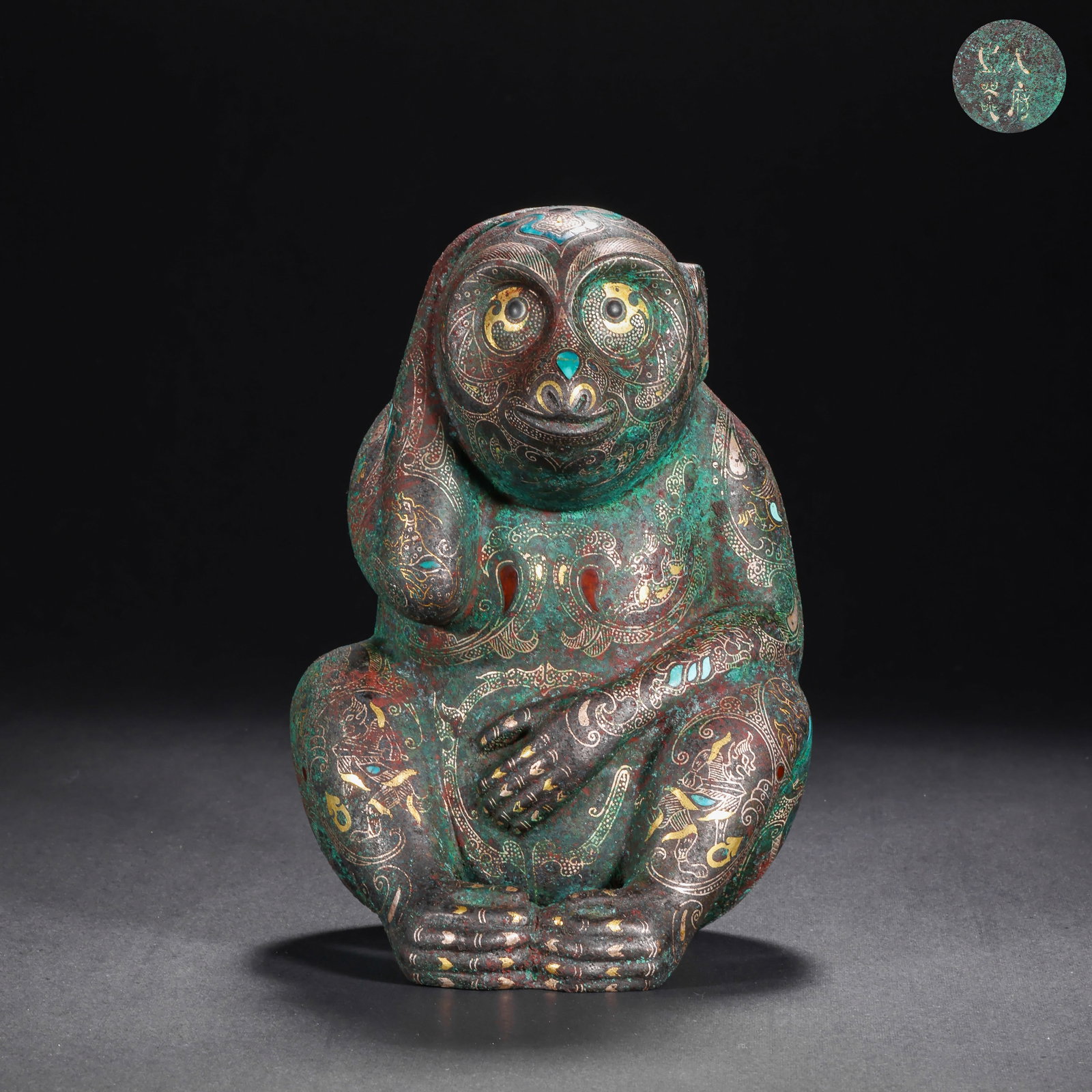 BRONZE INLAID WITH GOLD AND SILVER INLAID WITH GEMSTONES MONKEY FIGURINE FROM THE HAN DYNASTY: H:14.5cm(5.71in) W:9.5cm(3.74in) Weight:970g(2.14lb)This artifact is cast in bronze, fully decorated with cloud and beast patterns on the monkey's body using gold and silver inlay technique, inlaid wi
