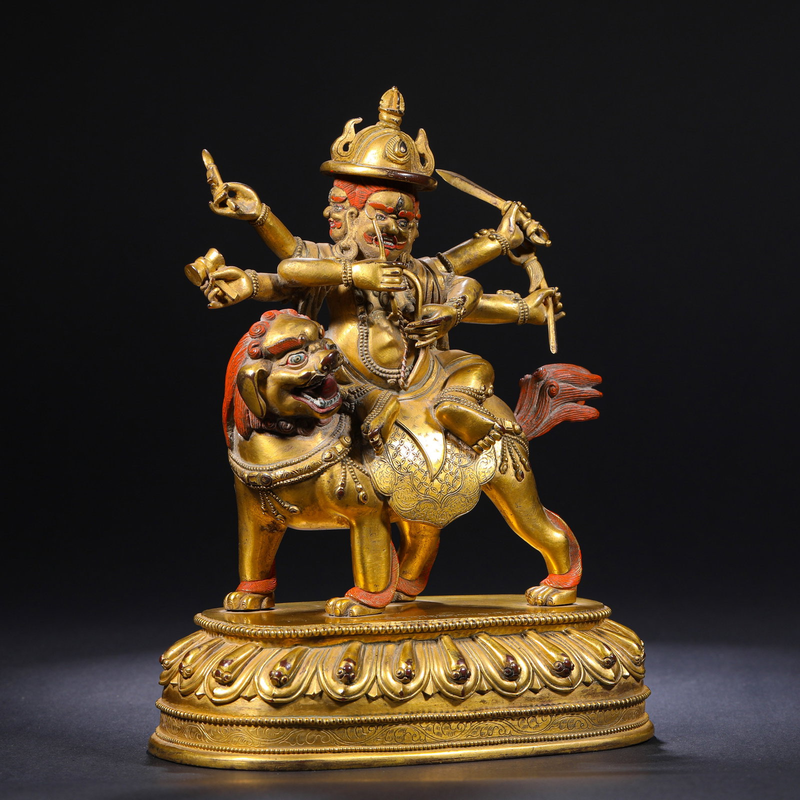 A GILDED BRONZE STATUE OF A SIX-ARMED WRATHFUL FIGURE RIDING A LION IN TIBETAN BUDDHISM FROM THE: H:20cm(7.87in)W:14.5cm(5.71in)Weight:1950g This is a Tibetan Buddhist six-armed wrathful deity riding a lion statue; its fierce expression, ritual implements, and mount symbolize the power of Dharma p