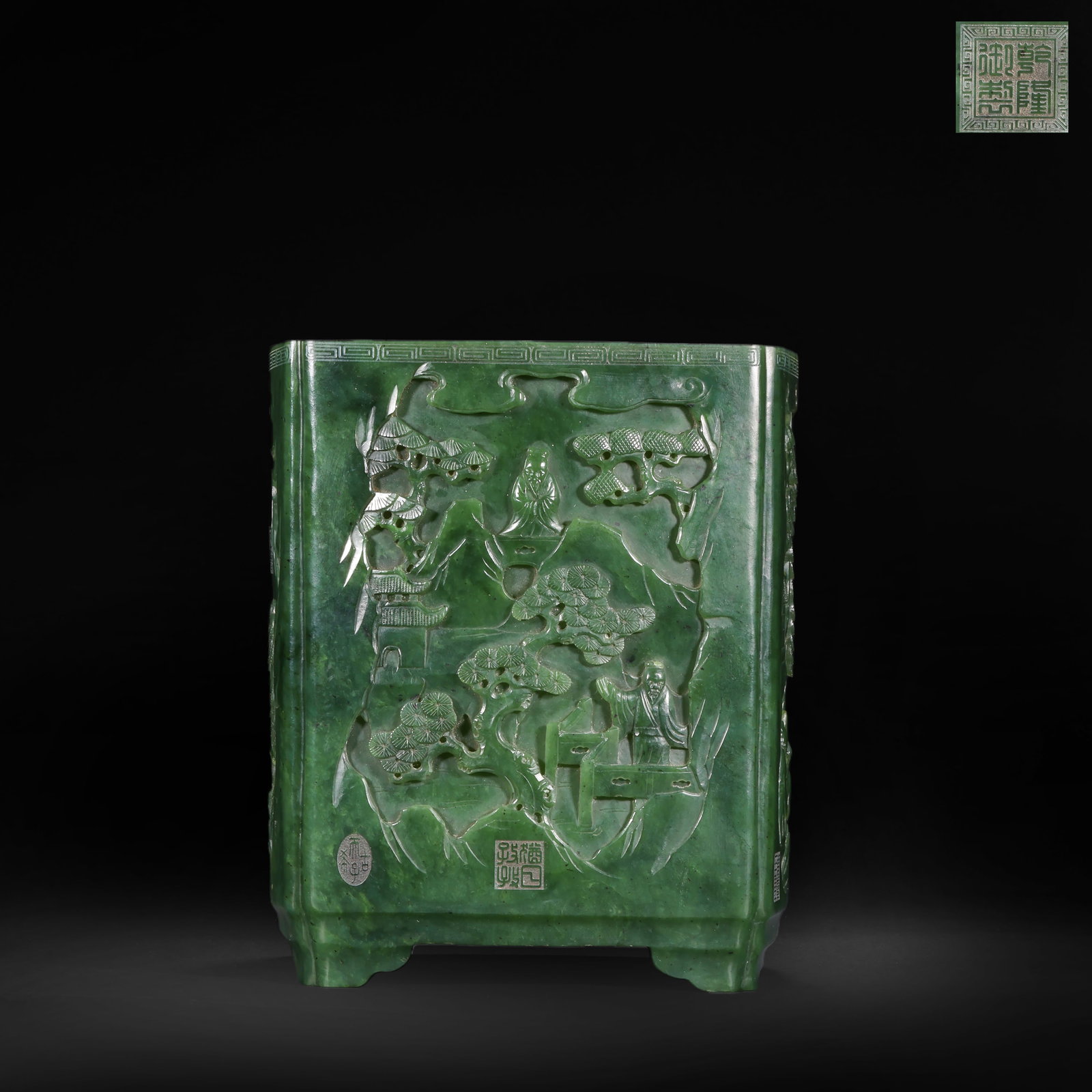 QING DYNASTY GREEN JADE HIGH RELIEF OF LANDSCAPE AND FIGURE PATTERNS SQUARE PEN HOLDER: H:18.0cm(7.09in) W:16.0cm(6.30in) Weight:3360g(7.41lb)This brush pot is carved from a single piece of dark green Hetian jasper, square in shape with angled feet. The body is fully decorated in high-re