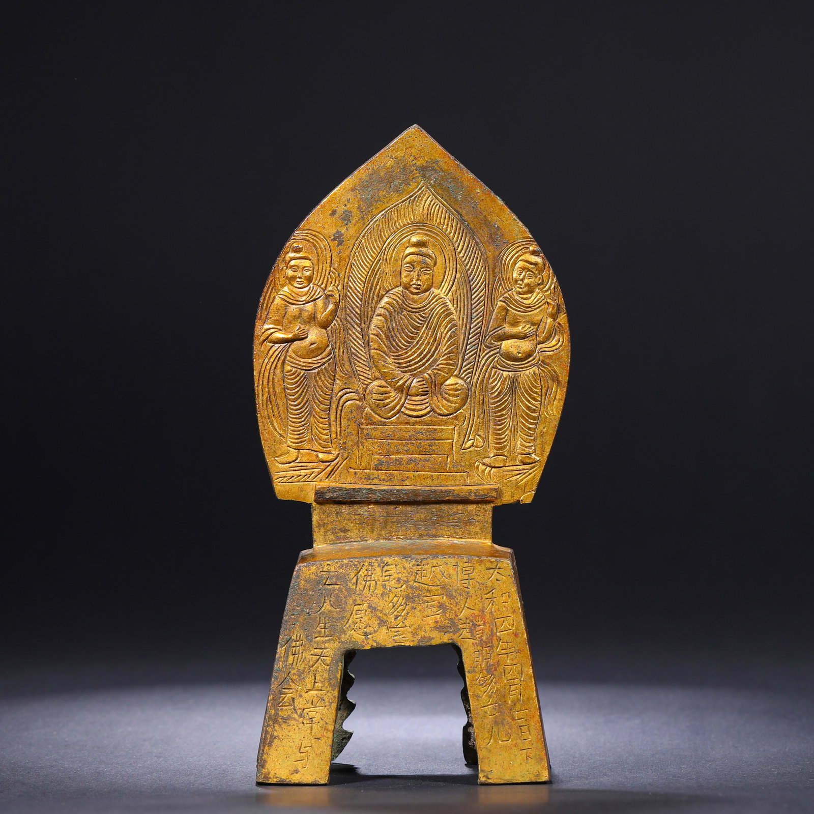 A GILDED BRONZE STATUE OF A BODHISATTVA FROM THE NORTHERN WEI DYNASTY: H:19.5cm(7.68in)W:9.3cm(3.66in)Weight:780g This double-sided gilded bronze Buddhist shrine, dated to the 4th year of Taihe (480 CE) of the Northern Wei Dynasty, has a complete dated votive inscription