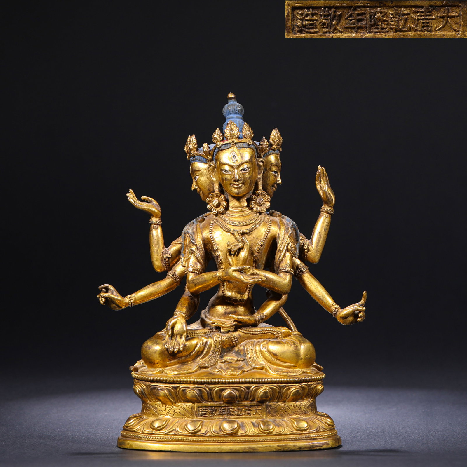 A GILDED BRONZE SEATED STATUE OF THE BUDDHA MOTHER OF THE QING DYNASTY'S QIANLONG PERIOD: H:19cm(7.48in)W:14cm(5.51in)Weight:1550g This gilded bronze seated U????a Vijaya, with clear official Qianlong inscriptions and standard craftsmanship, is a typical representative of Qing court Tibeta